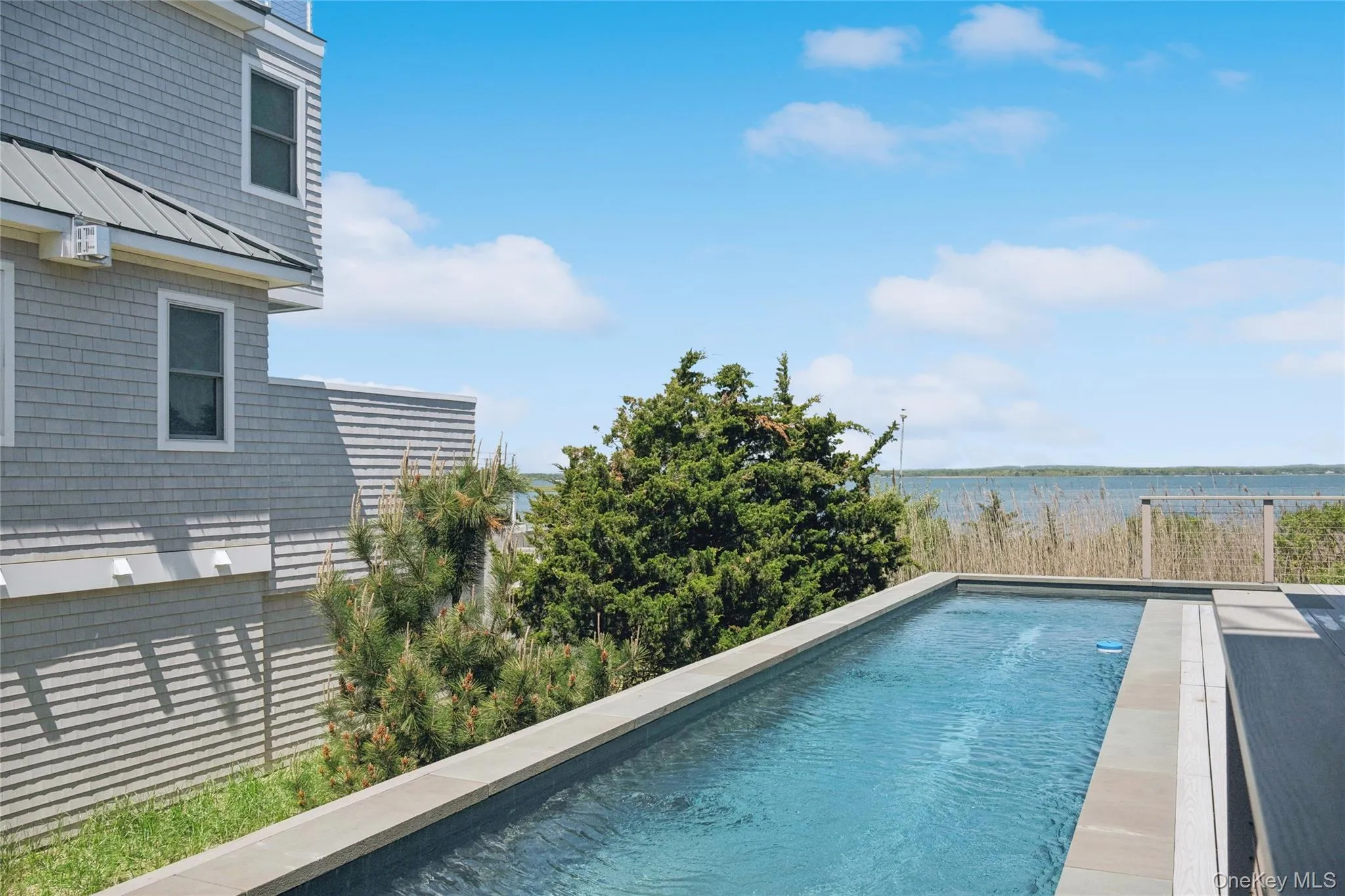 Pool featuring a water view Pool featuring a water view