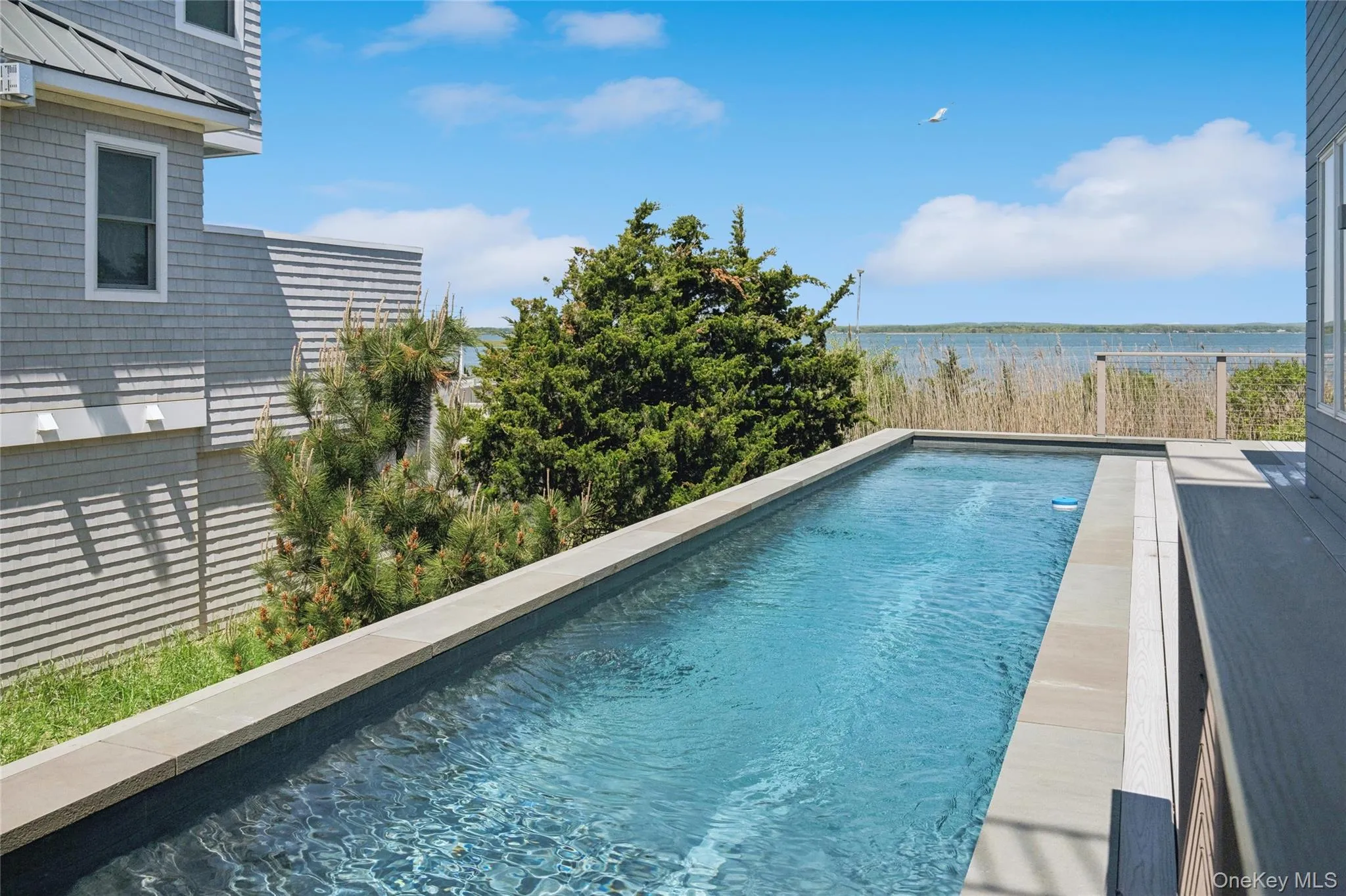 Outdoor pool featuring a water view Outdoor pool featuring a water view