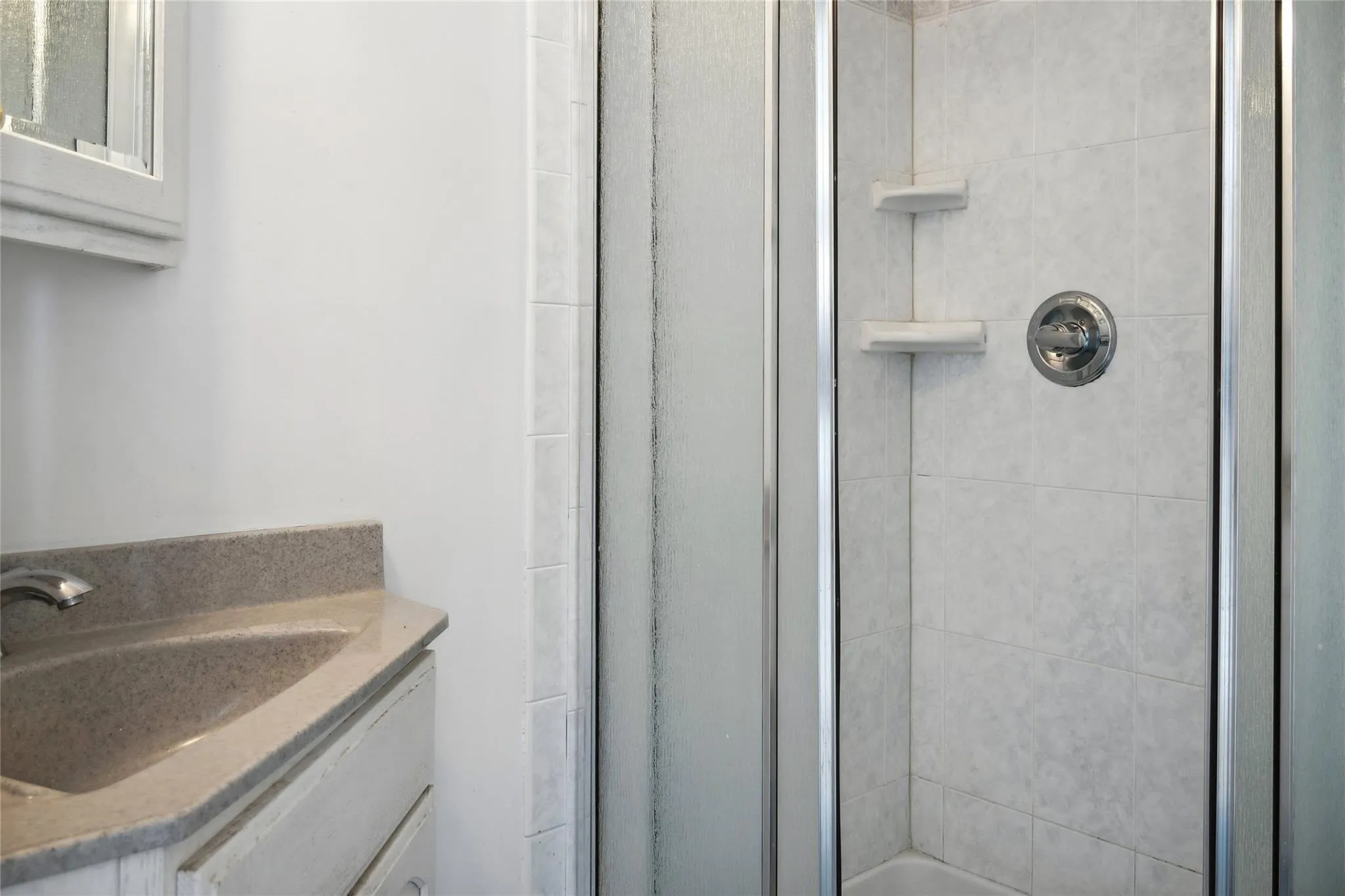 Bathroom with vanity and an enclosed shower Bathroom with vanity and an enclosed shower