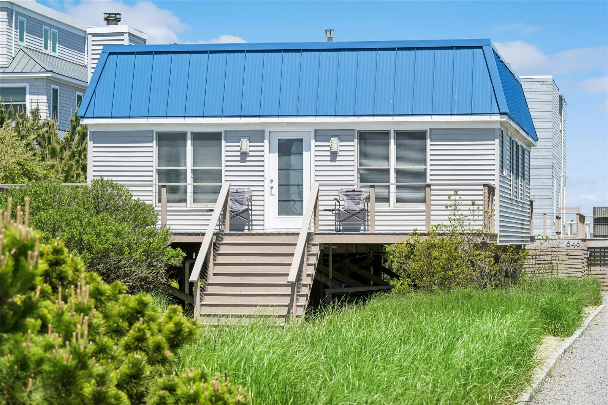 View of front of house with stairs, metal roof, and a deck View of front of house with stairs, metal roof, and a deck