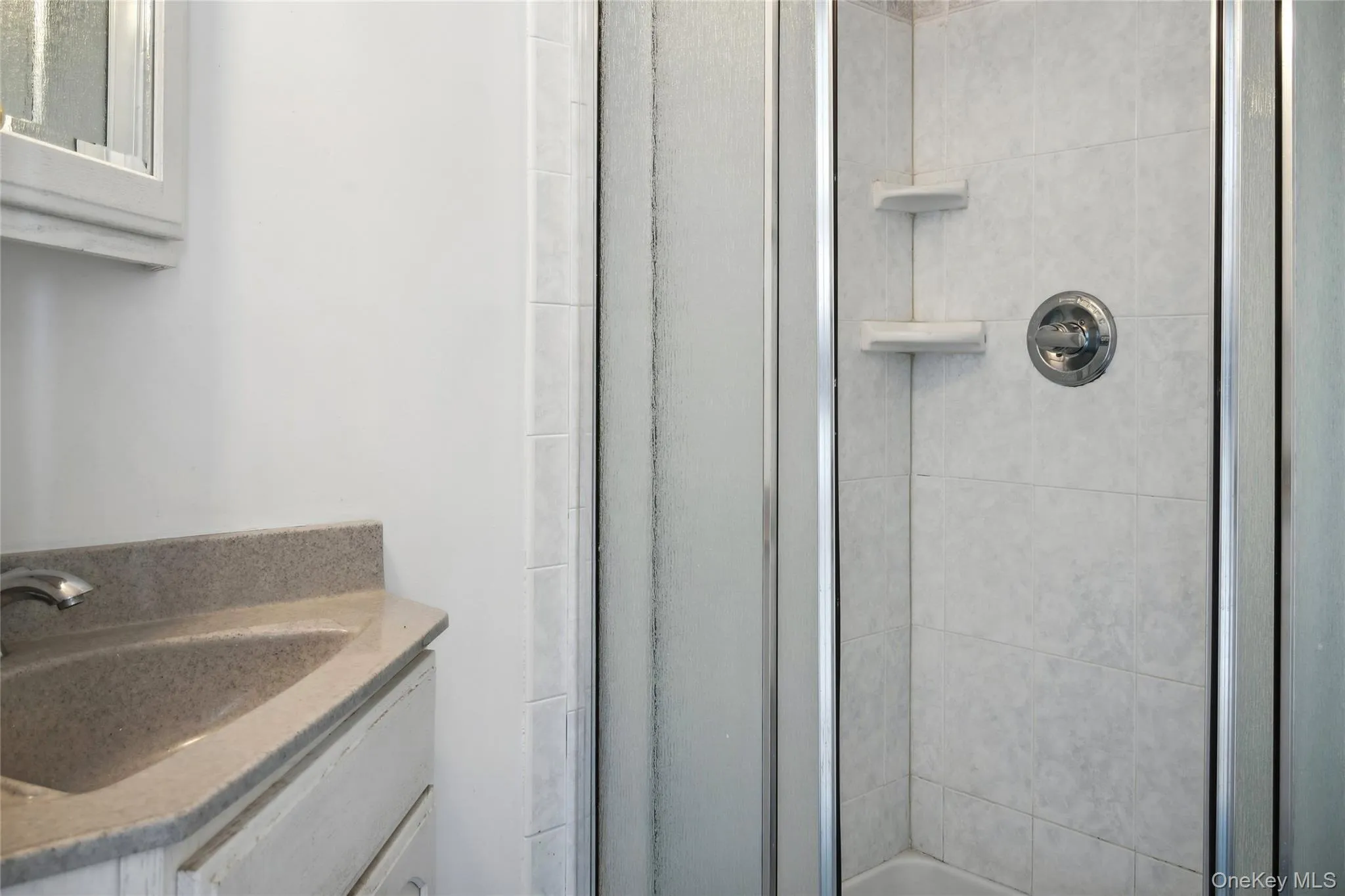 Bathroom with vanity and an enclosed shower Bathroom with vanity and an enclosed shower