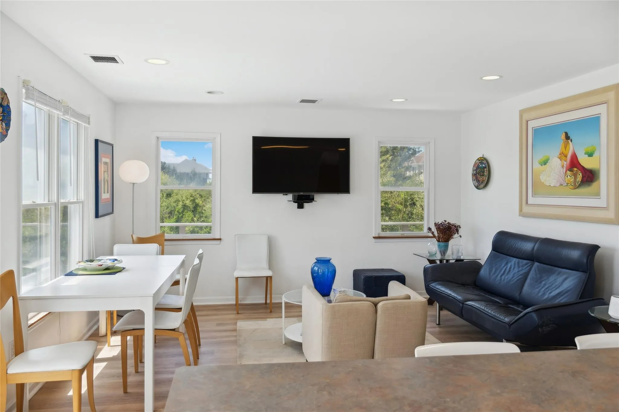 Living area featuring light wood finished floors, baseboards, visible vents, and recessed lighting Living area featuring light wood finished floors, baseboards, visible vents, and recessed lighting