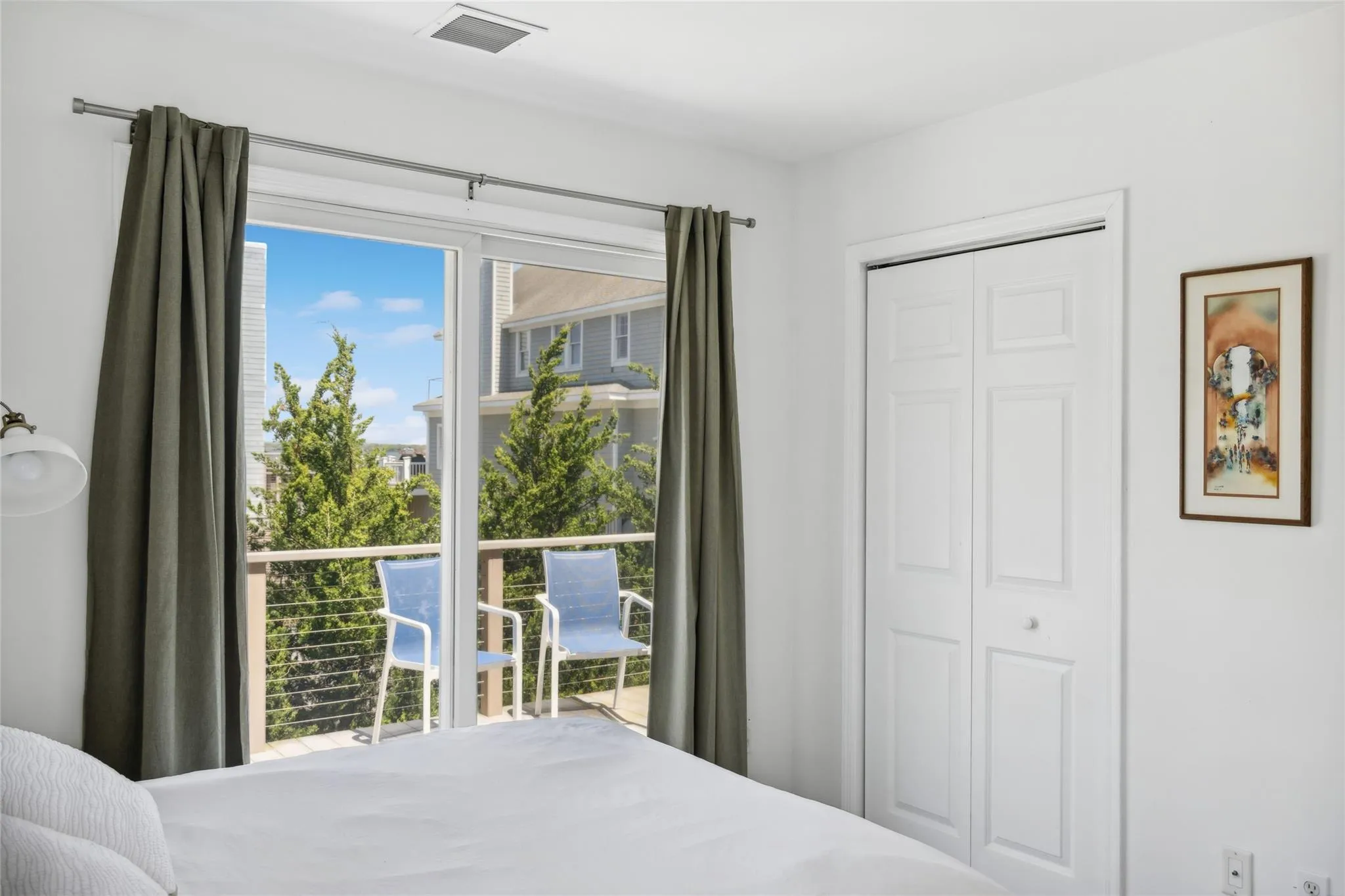 Bedroom with a closet and visible vents Bedroom with a closet and visible vents