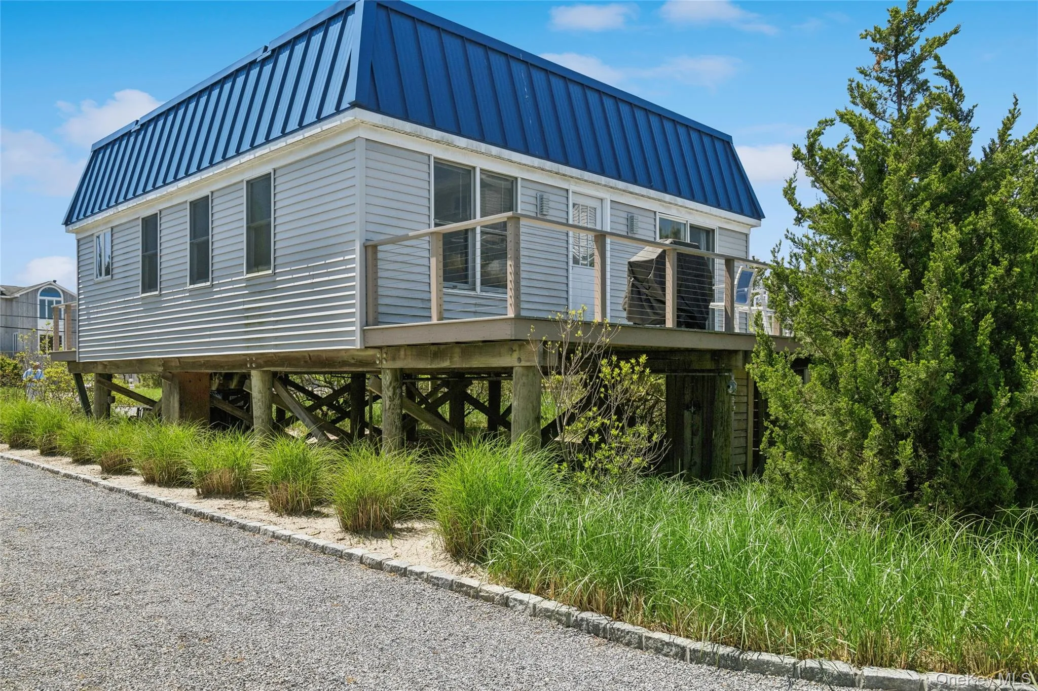 View of property exterior featuring metal roof and a standing seam roof View of property exterior featuring metal roof and a standing seam roof