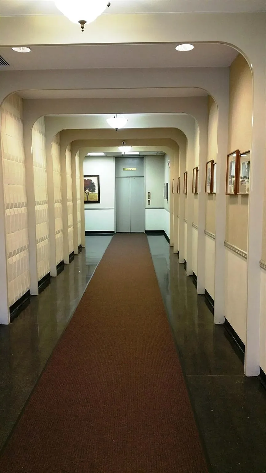 Hall with elevator, arched walkways, and visible vents Hall with elevator, arched walkways, and visible vents