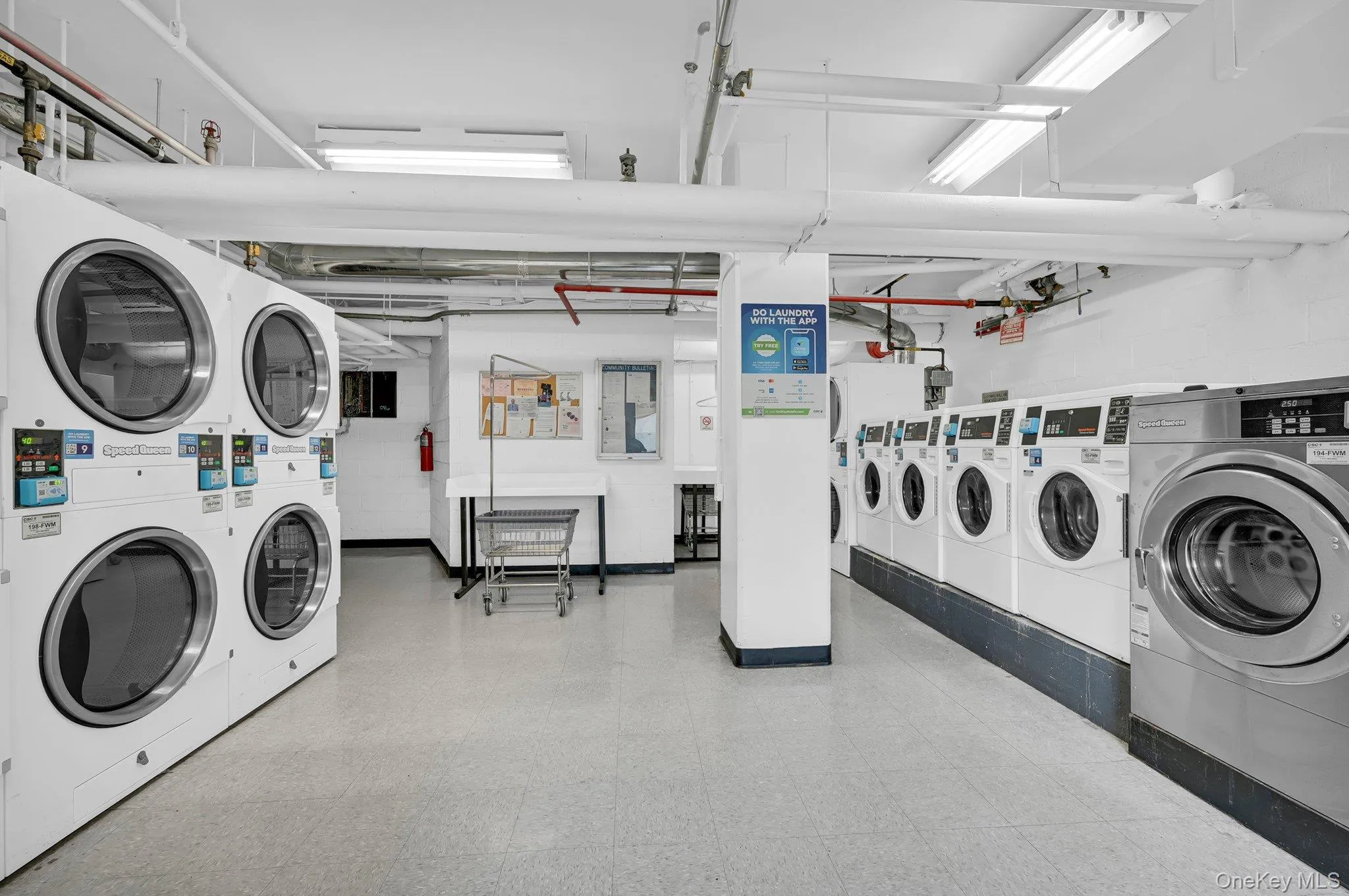 Shared laundry area with stacked washing maching and dryer and washer and clothes dryer Shared laundry area with stacked washing maching and dryer and washer and clothes dryer