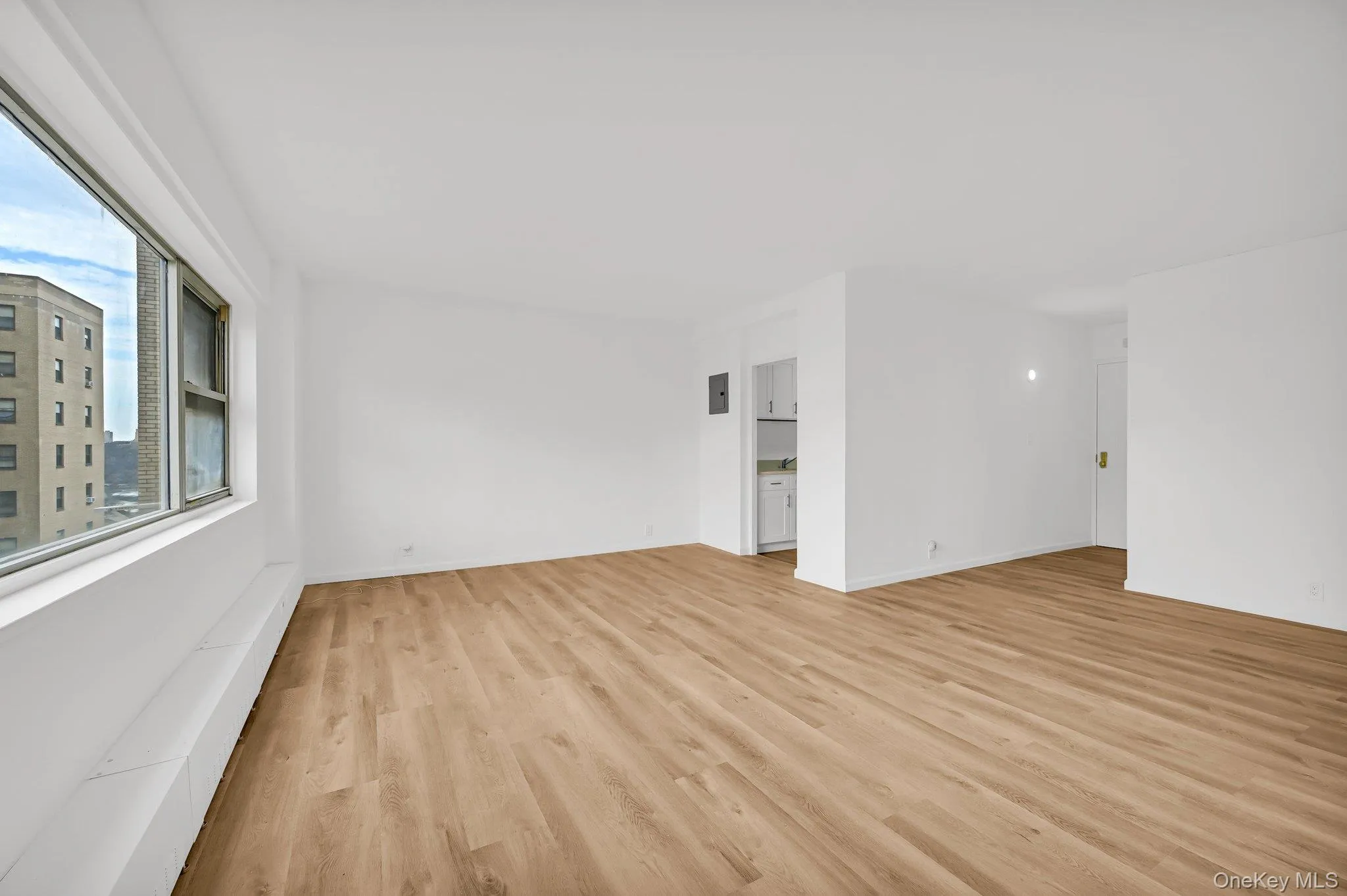 view of Living room & dining room with baseboards and light wood-style flooring view of Living room & dining room with baseboards and light wood-style flooring
