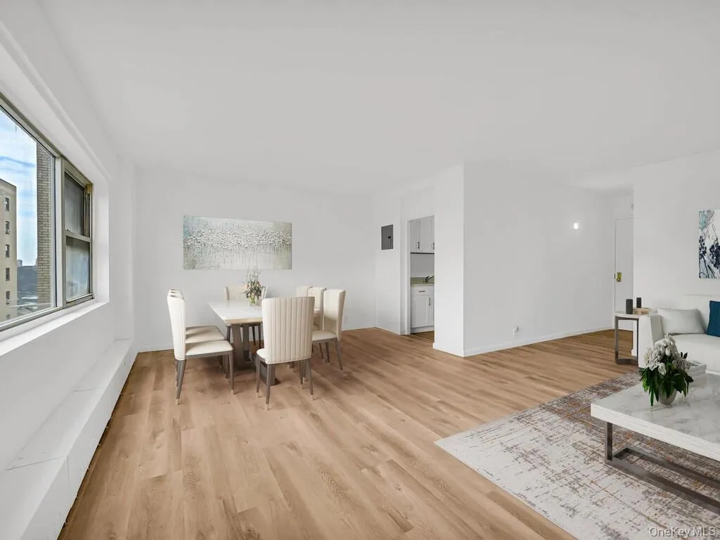 Virtually staged Dining area featuring light wood-style flooring and baseboards Virtually staged Dining area featuring light wood-style flooring and baseboards