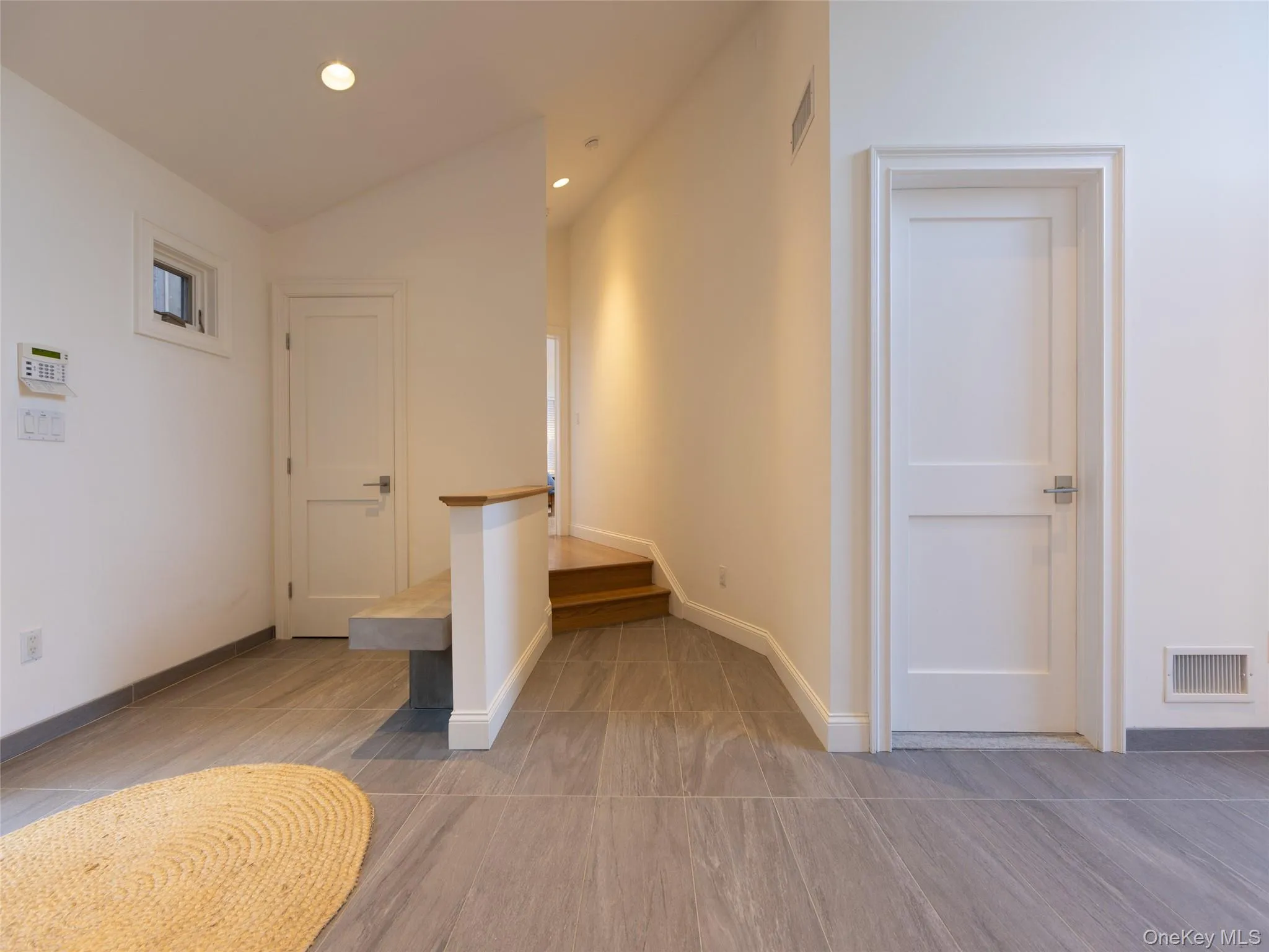 Hall featuring visible vents, baseboards, recessed lighting, and vaulted ceiling Hall featuring visible vents, baseboards, recessed lighting, and vaulted ceiling