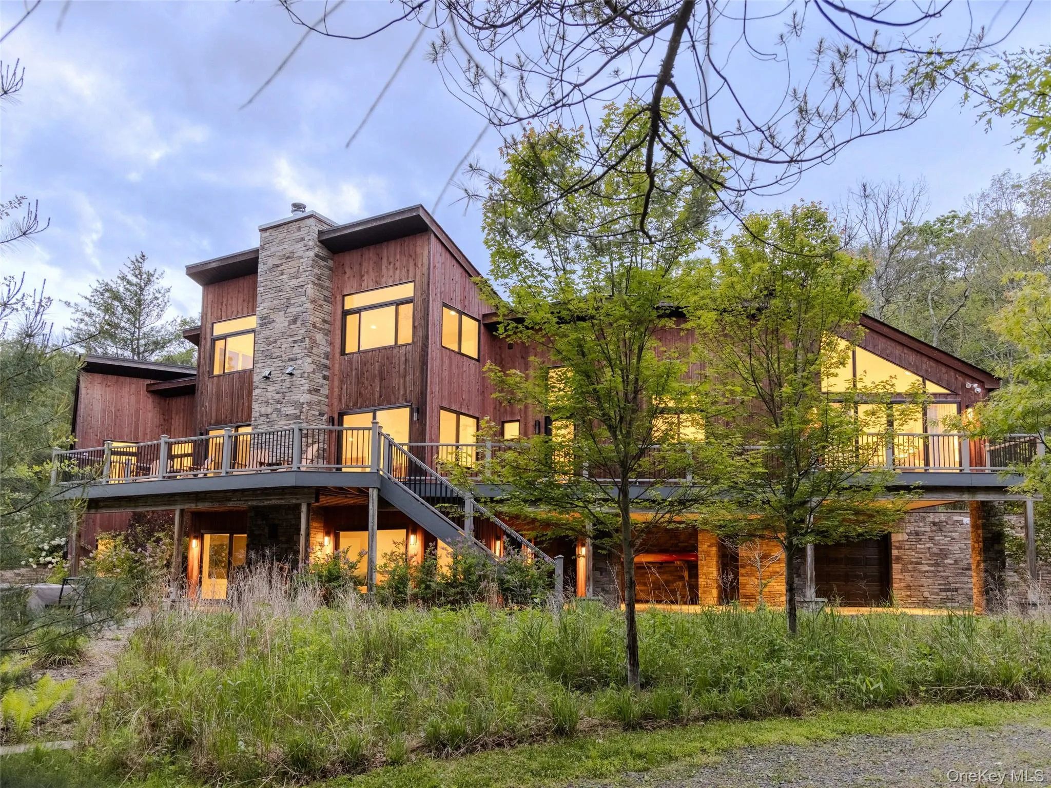 Back of property with a chimney, stairway, and a wooden deck Back of property with a chimney, stairway, and a wooden deck