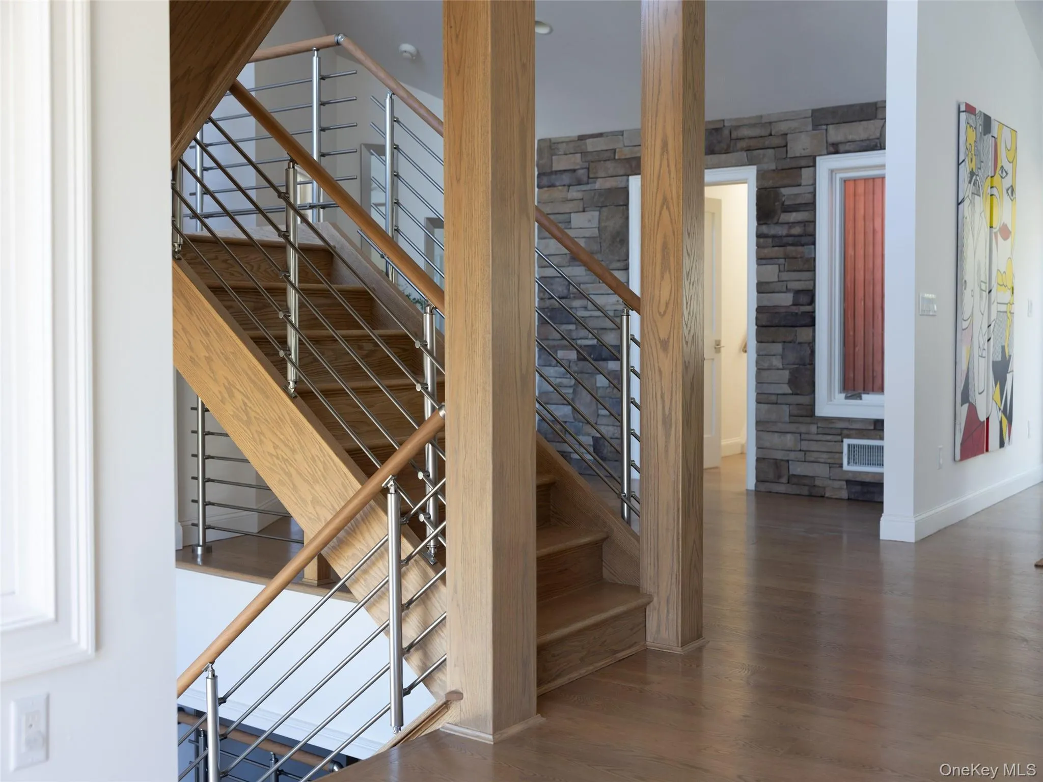 Stairway featuring visible vents, baseboards, and wood finished floors Stairway featuring visible vents, baseboards, and wood finished floors