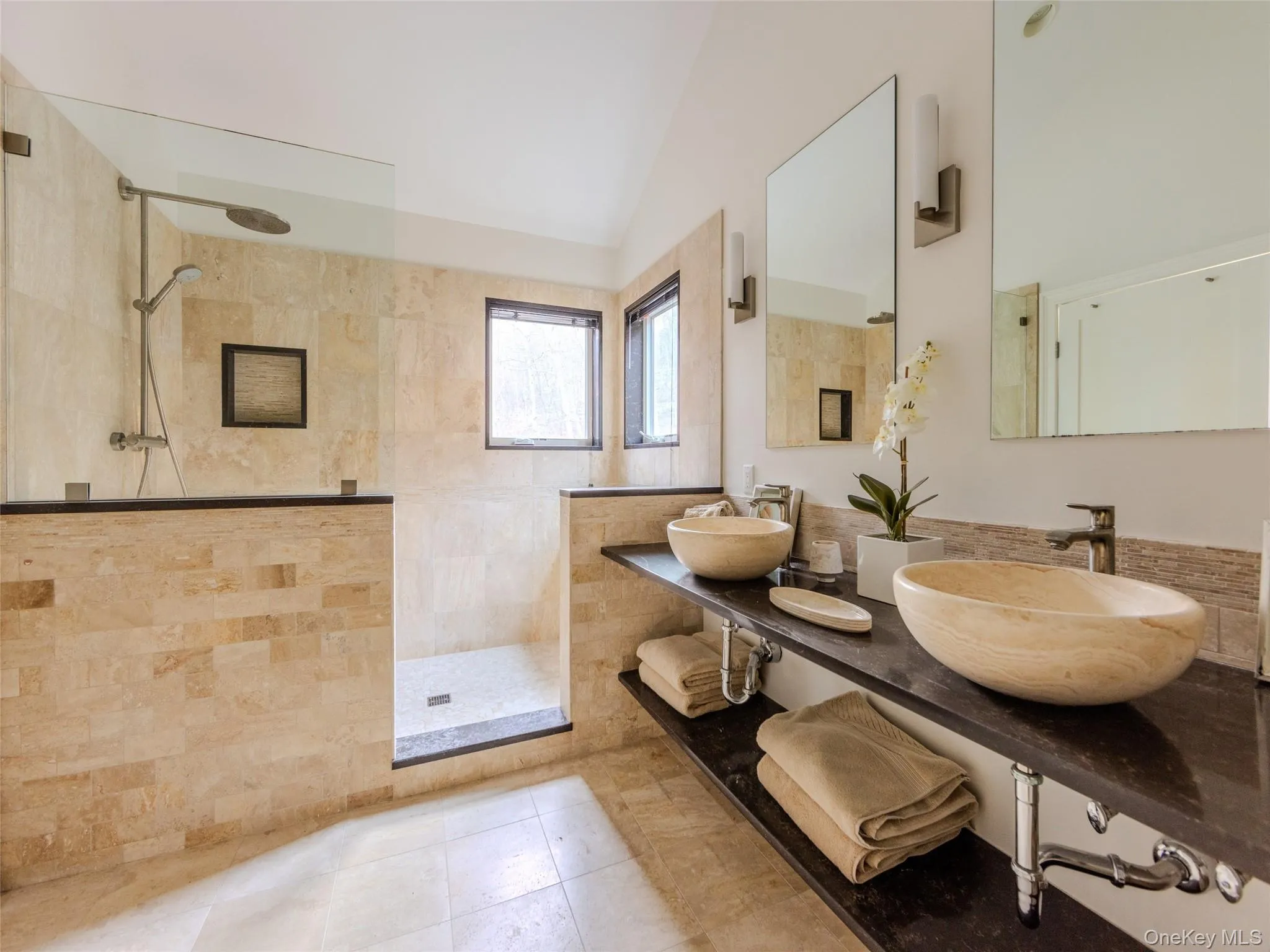 Full bathroom featuring a walk in shower, a sink, and lofted ceiling Full bathroom featuring a walk in shower, a sink, and lofted ceiling