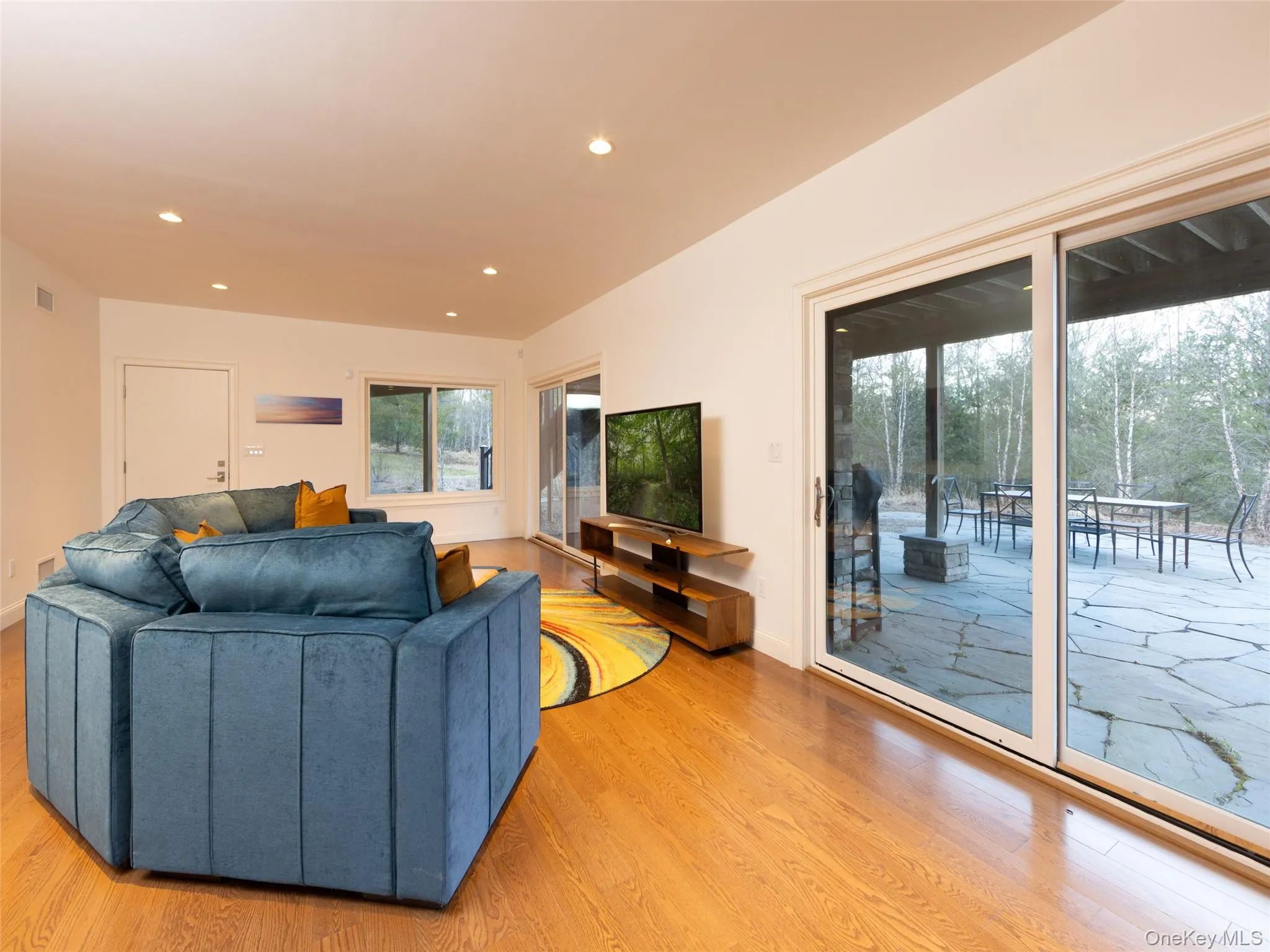 Living area featuring recessed lighting, light wood finished floors, and visible vents Living area featuring recessed lighting, light wood finished floors, and visible vents