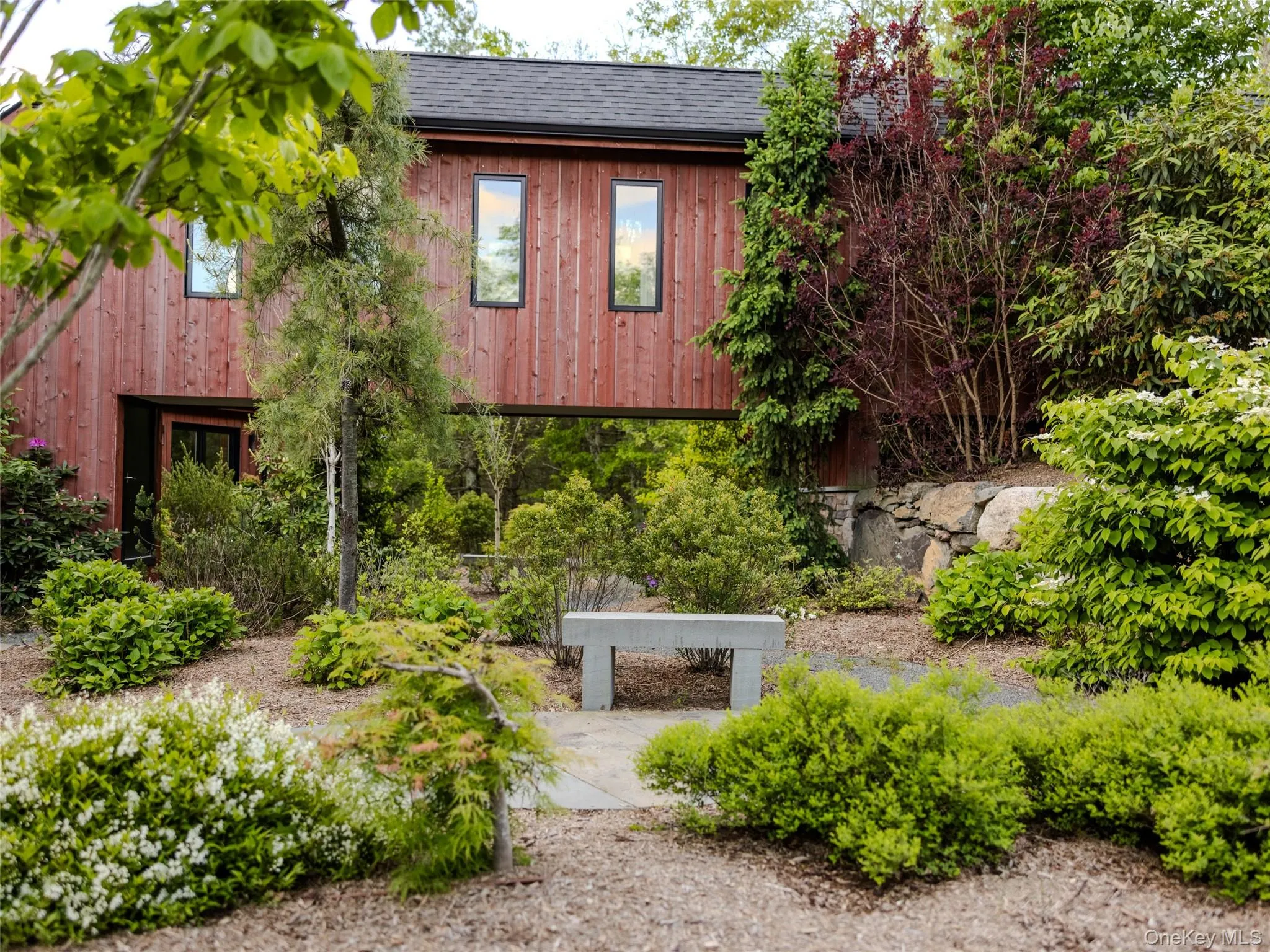 View of side of home featuring a chimney and a shingled roof View of side of home featuring a chimney and a shingled roof