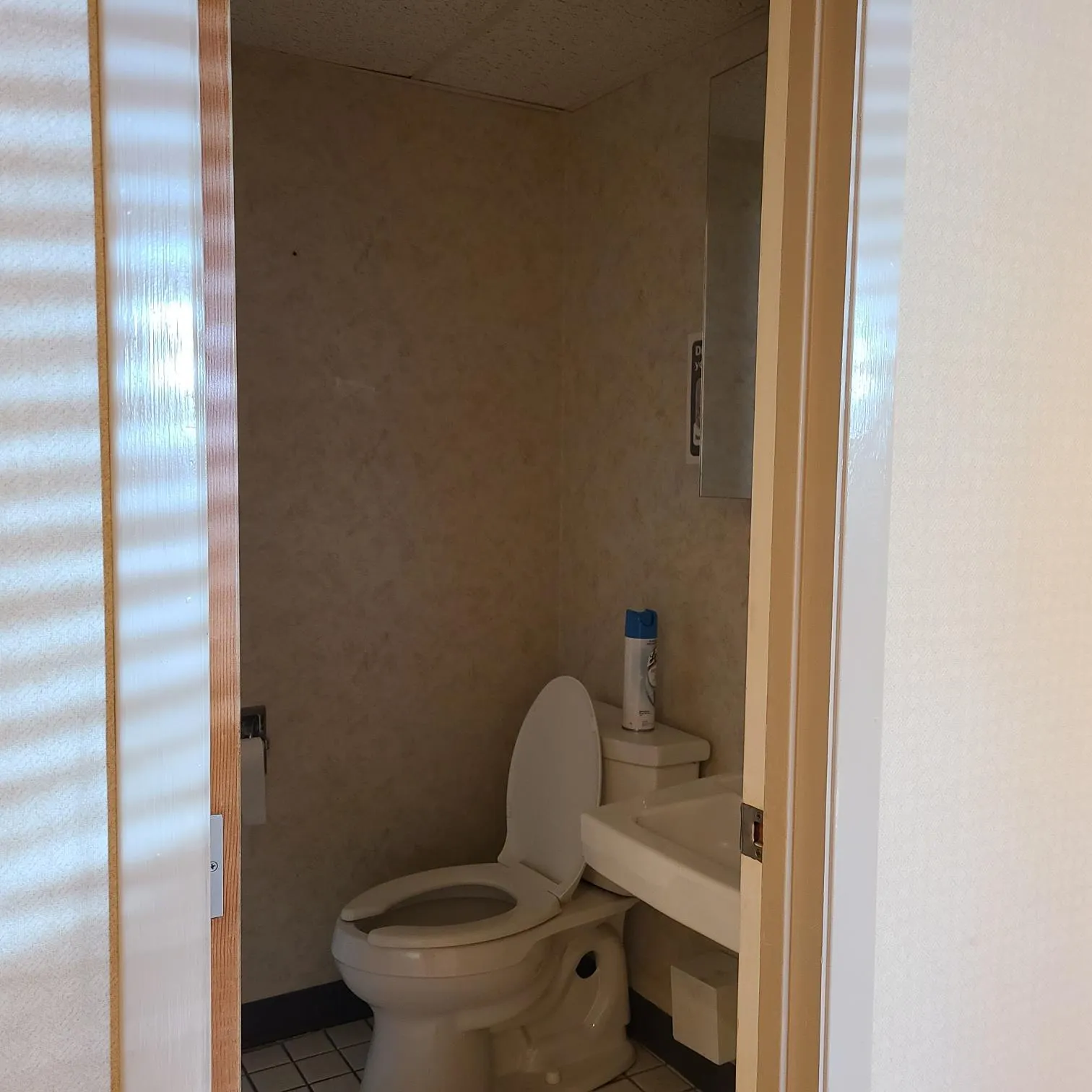 Half bathroom with tile patterned floors and toilet Half bathroom with tile patterned floors and toilet