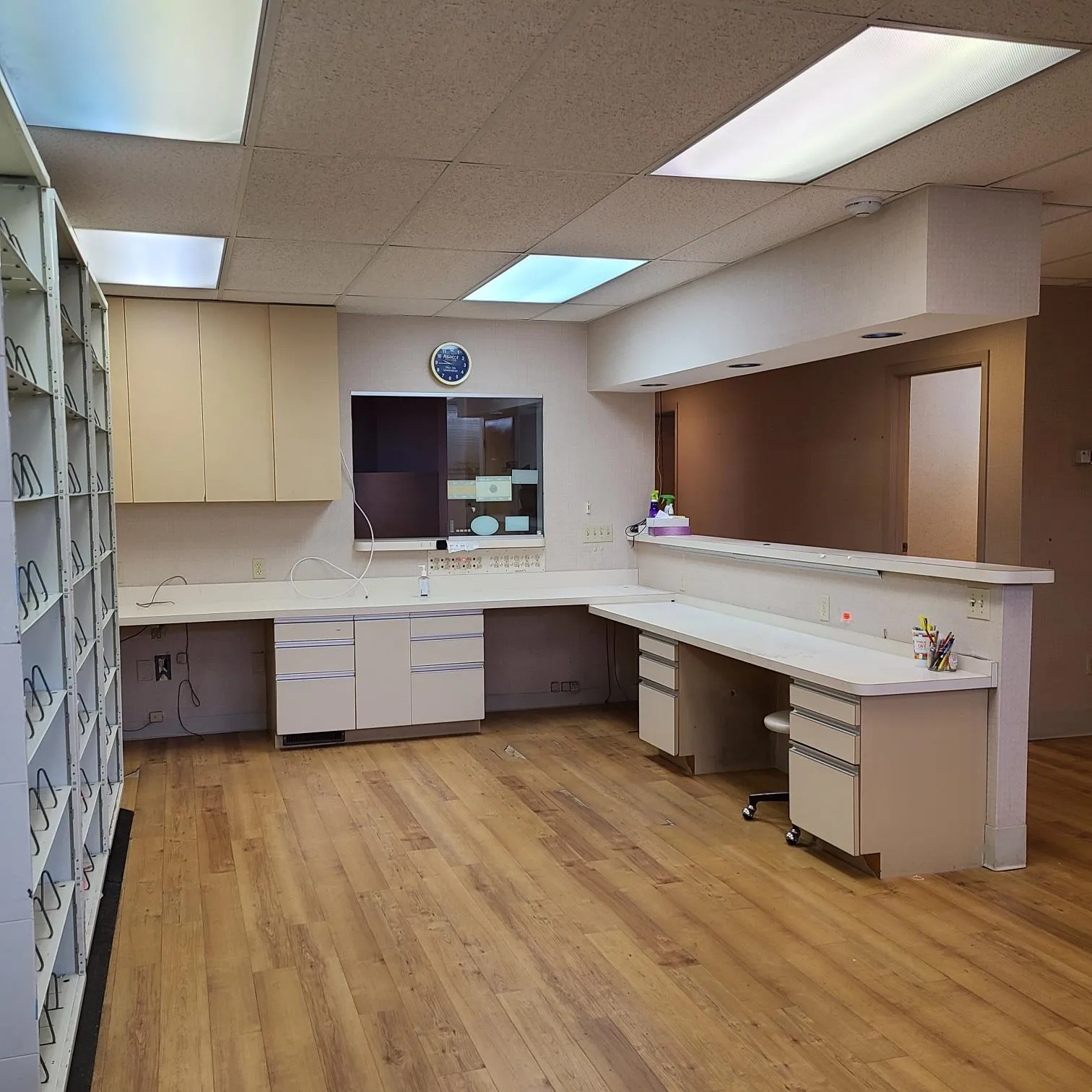 Kitchen with built in desk, light countertops, a peninsula, and light wood finished floors Kitchen with built in desk, light countertops, a peninsula, and light wood finished floors