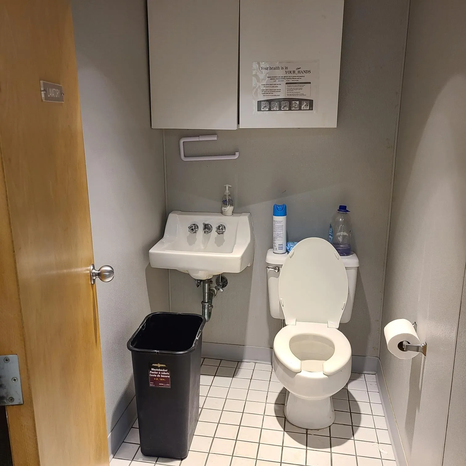 Half bathroom with tile patterned floors, a sink, toilet, and baseboards Half bathroom with tile patterned floors, a sink, toilet, and baseboards