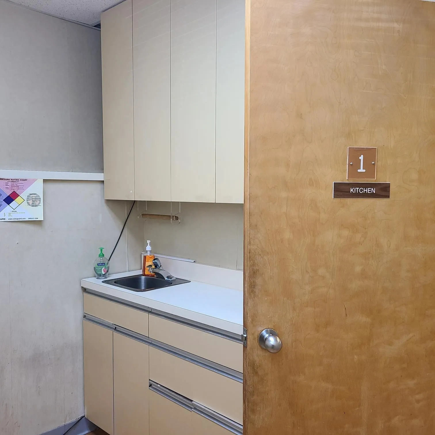 Kitchen with white cabinetry, light countertops, and a sink Kitchen with white cabinetry, light countertops, and a sink