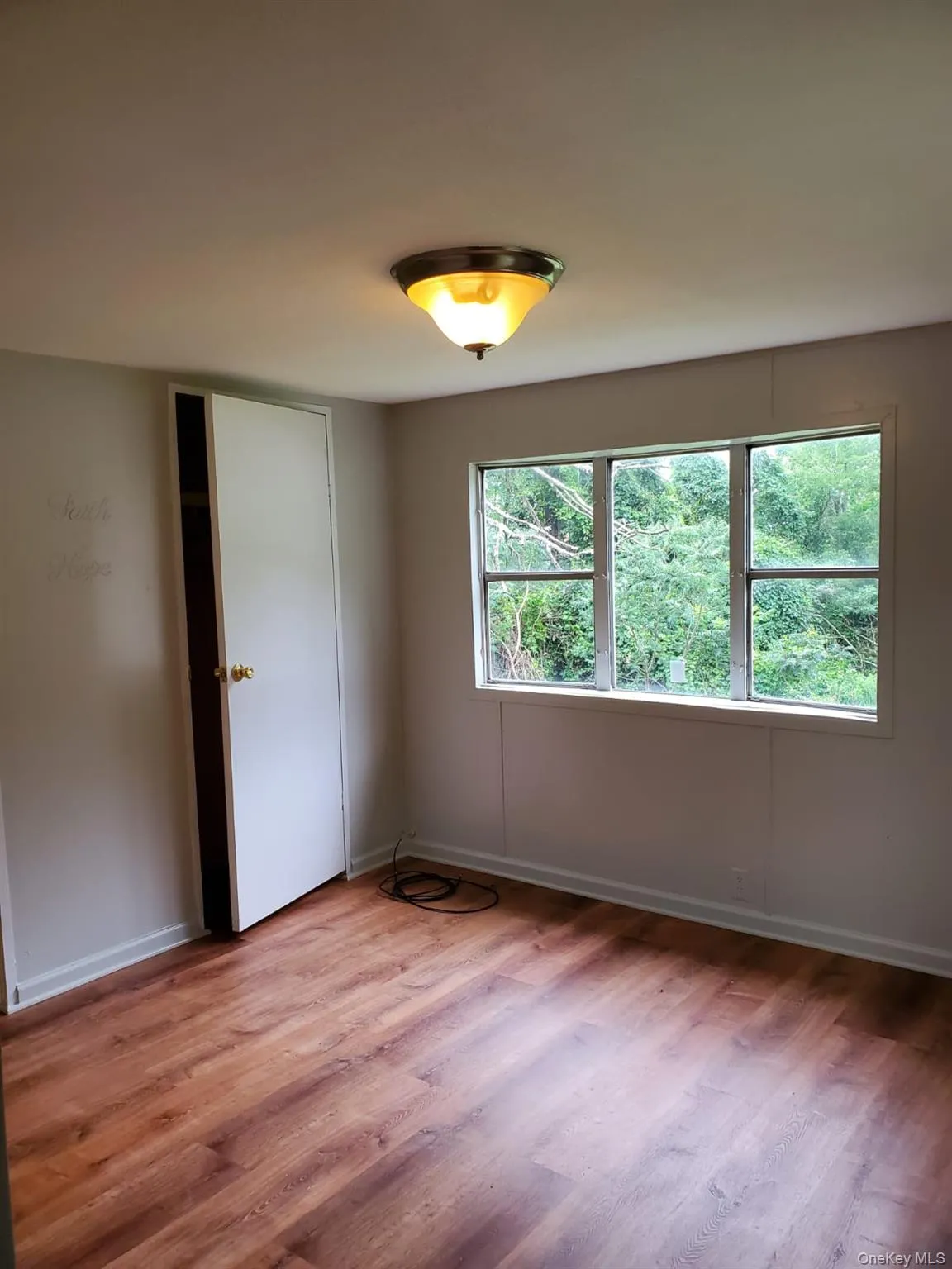 Empty room featuring baseboards and light wood finished floors Empty room featuring baseboards and light wood finished floors