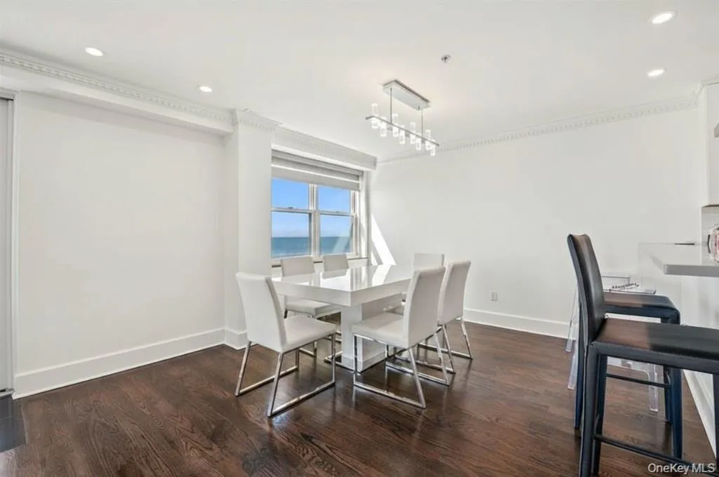 Dining room featuring recessed lighting and dark wood-style flooring Dining room featuring recessed lighting and dark wood-style flooring