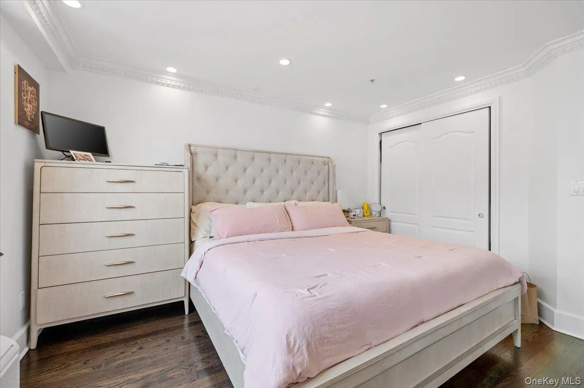 Bedroom featuring recessed lighting, dark wood-style floors, and crown molding Bedroom featuring recessed lighting, dark wood-style floors, and crown molding