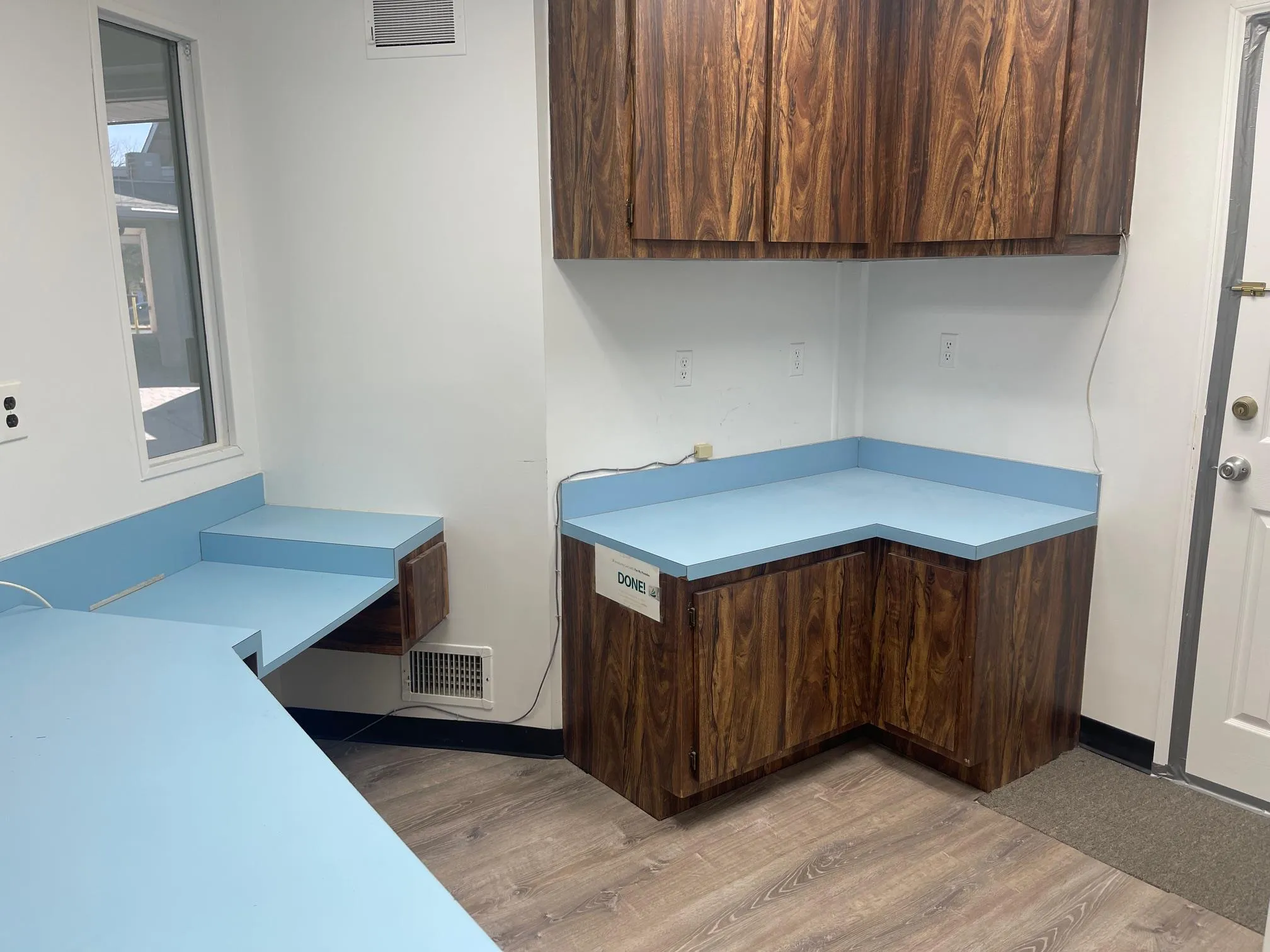 Office space featuring light wood-style flooring, visible vents, and plenty of natural light Office space featuring light wood-style flooring, visible vents, and plenty of natural light