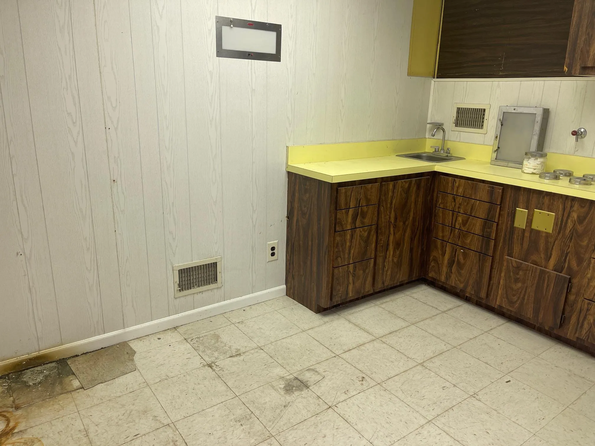 Kitchen featuring light floors, visible vents, light countertops, a sink, and baseboards Kitchen featuring light floors, visible vents, light countertops, a sink, and baseboards