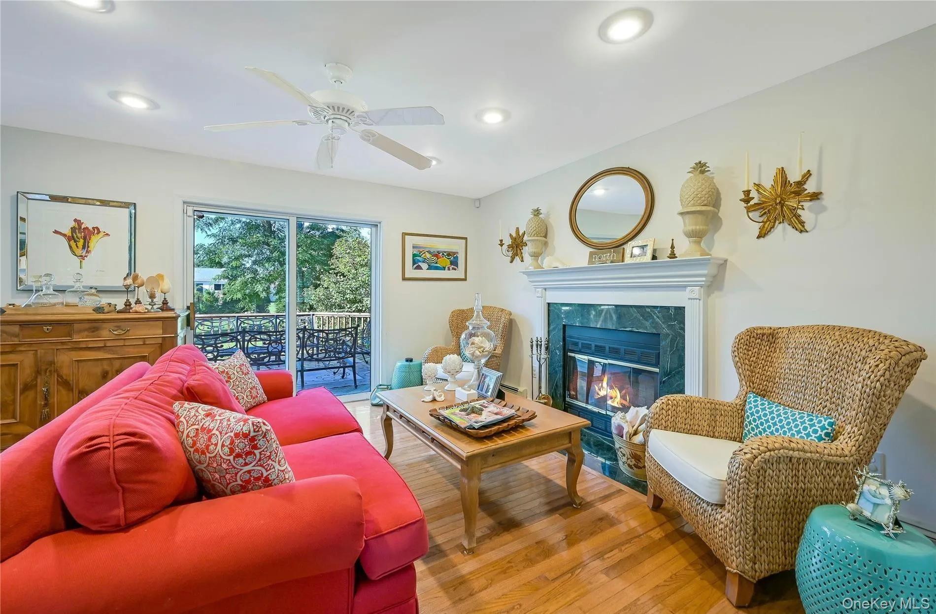 Living room with a ceiling fan, recessed lighting, a premium fireplace, and wood finished floors Living room with a ceiling fan, recessed lighting, a premium fireplace, and wood finished floors