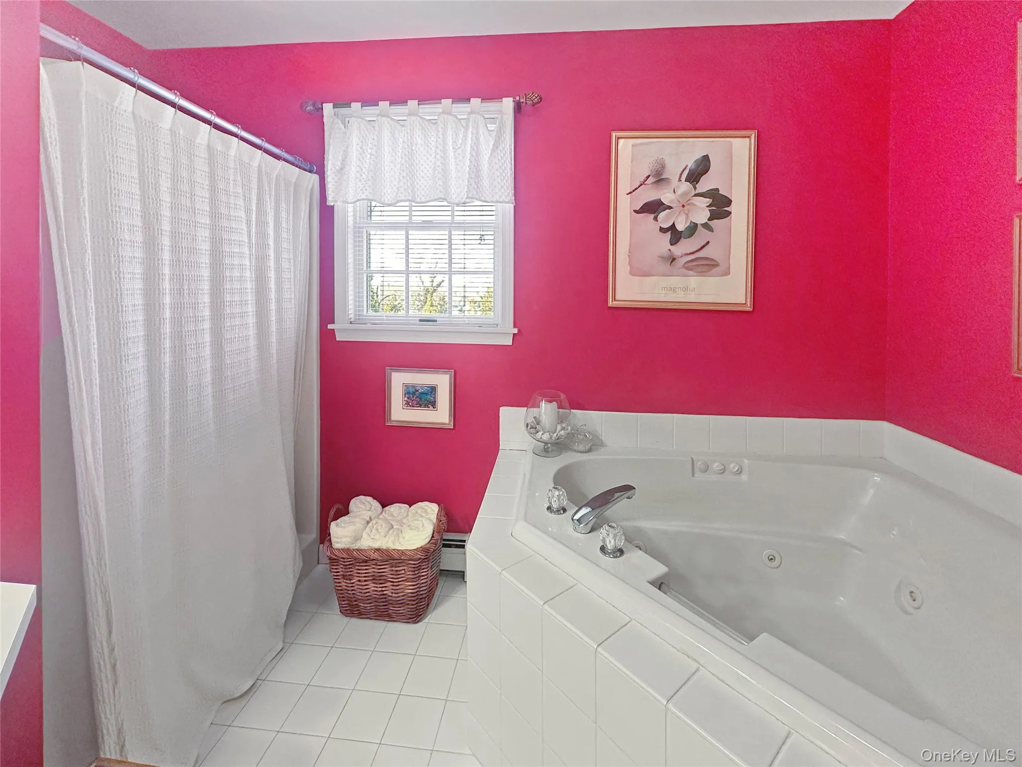 Full bath with a tub with jets, tile patterned floors, and a baseboard heating unit Full bath with a tub with jets, tile patterned floors, and a baseboard heating unit