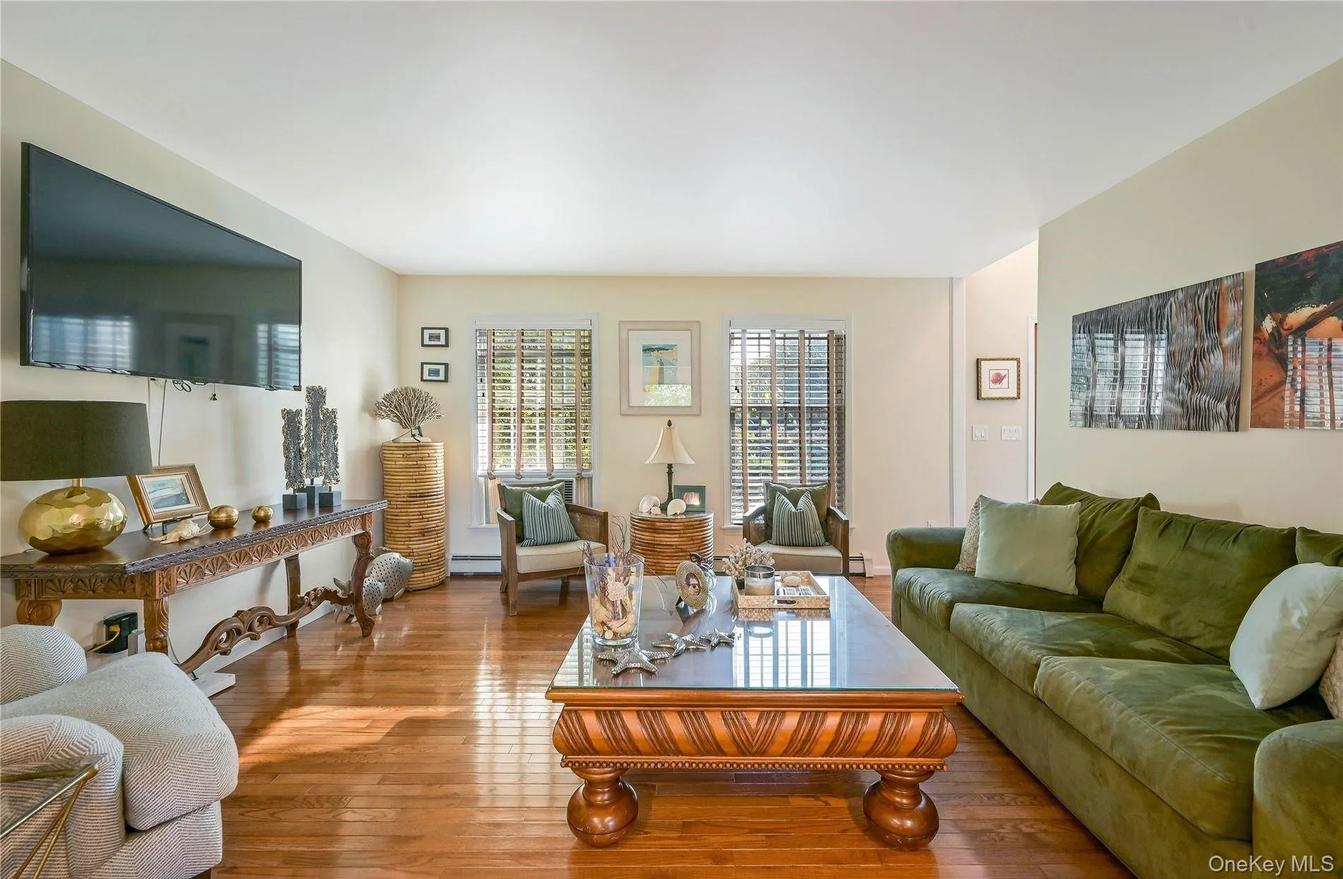 Living room with baseboard heating and wood finished floors Living room with baseboard heating and wood finished floors