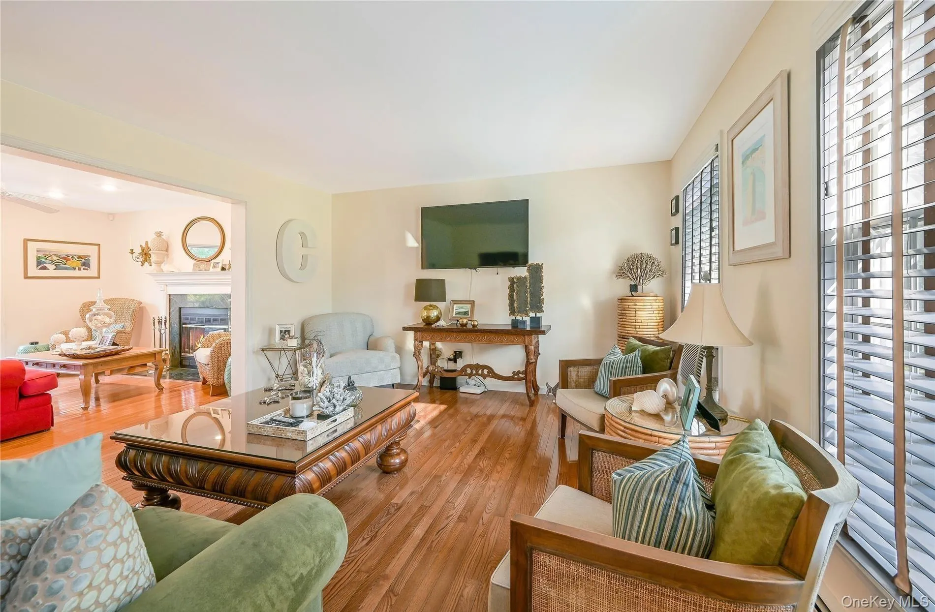 Living area featuring wood finished floors and a premium fireplace Living area featuring wood finished floors and a premium fireplace