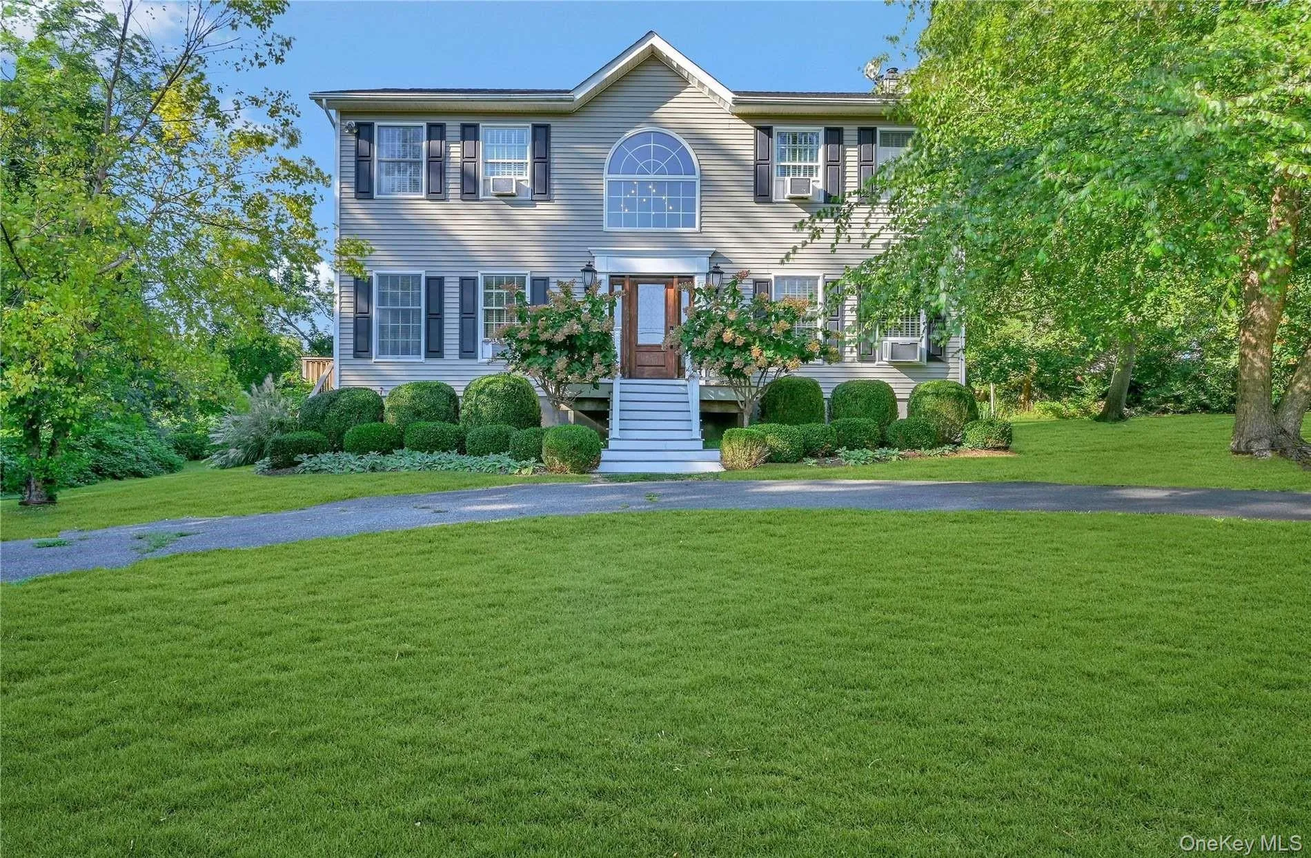 Colonial inspired home with a front lawn Colonial inspired home with a front lawn