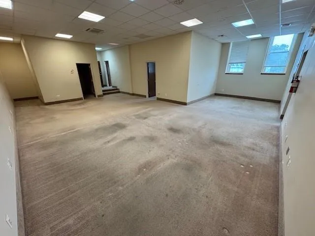 Carpeted empty room featuring a paneled ceiling Carpeted empty room featuring a paneled ceiling