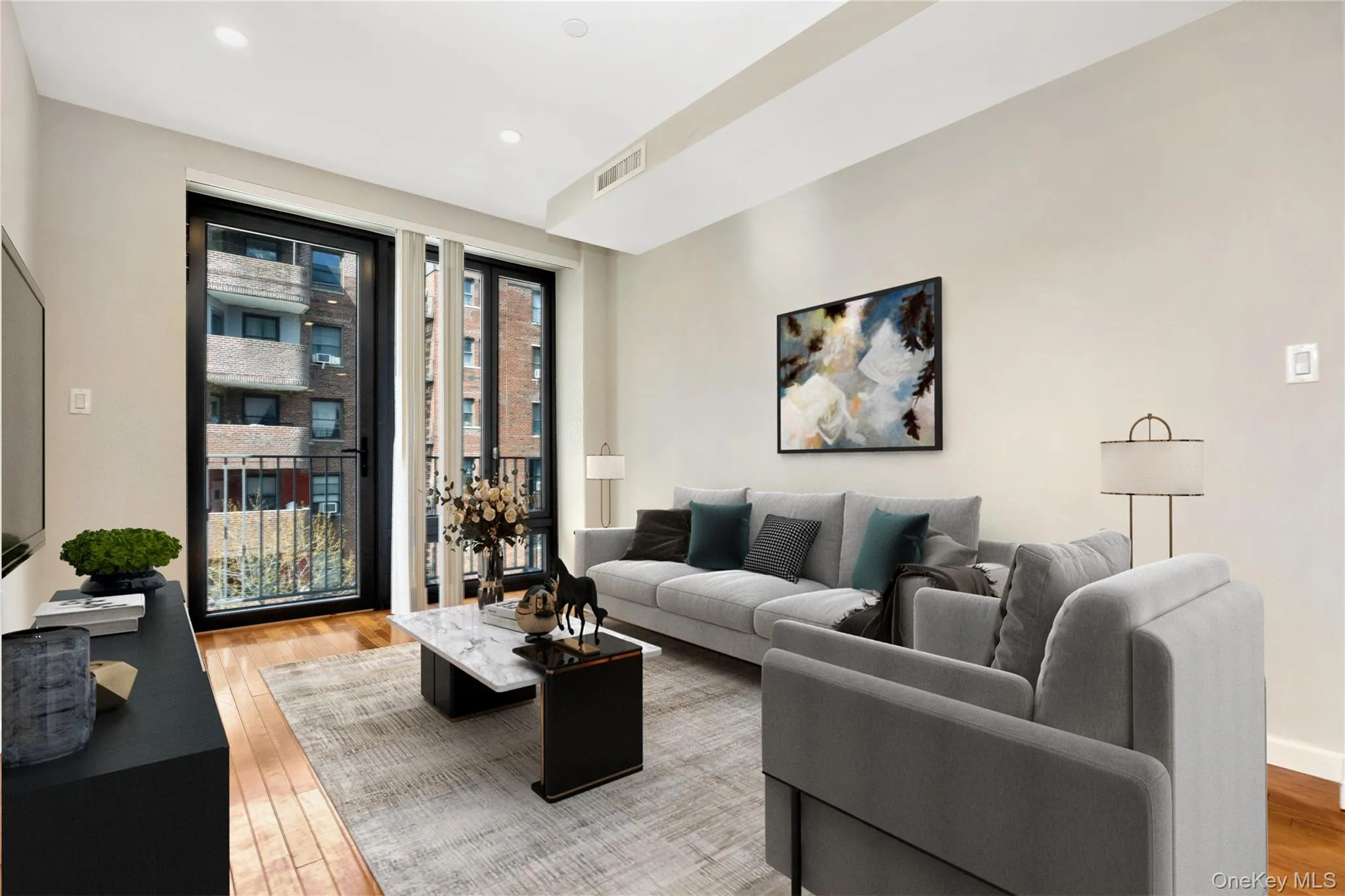Living area featuring recessed lighting, light wood finished floors, visible vents, and baseboards Living area featuring recessed lighting, light wood finished floors, visible vents, and baseboards