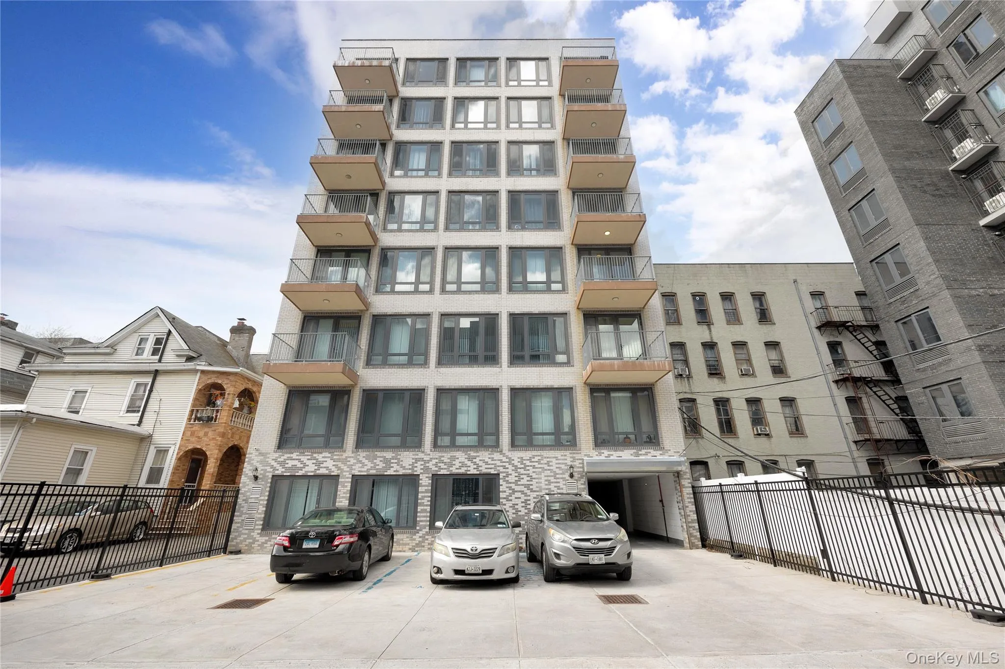 View of building exterior featuring fence View of building exterior featuring fence