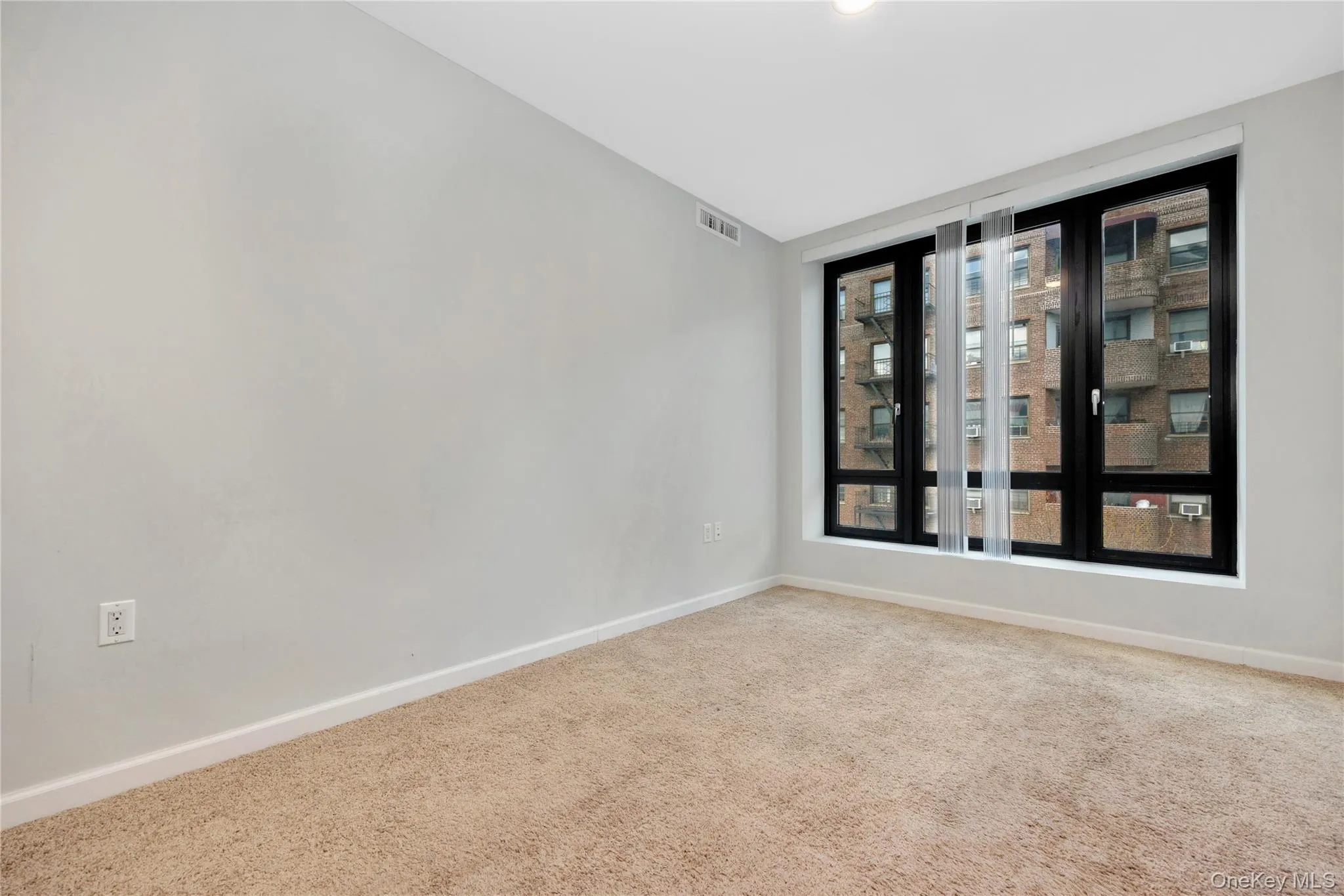 Empty room featuring carpet flooring, baseboards, and visible vents Empty room featuring carpet flooring, baseboards, and visible vents