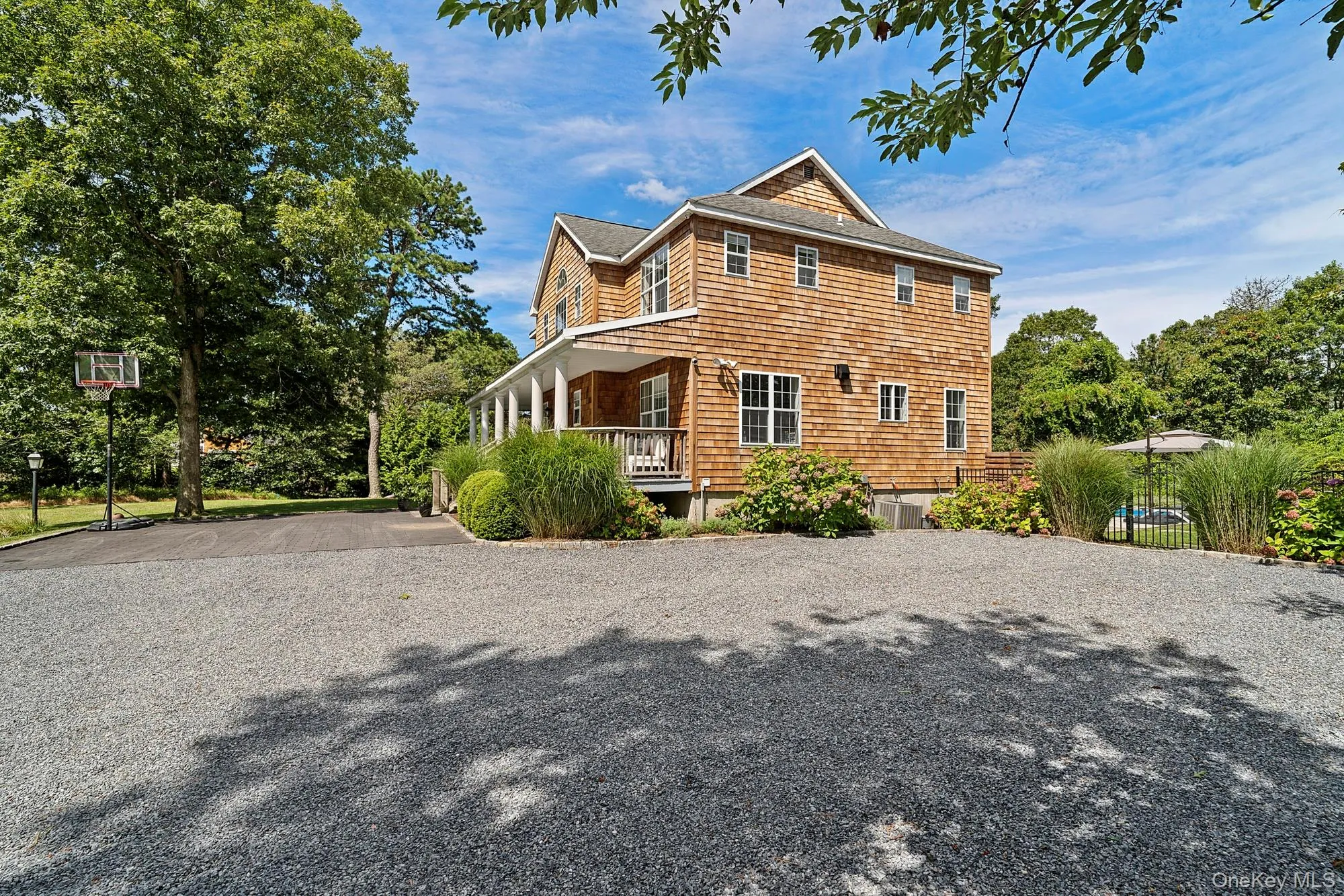 View of property exterior with covered porch, driveway, and roof with shingles View of property exterior with covered porch, driveway, and roof with shingles