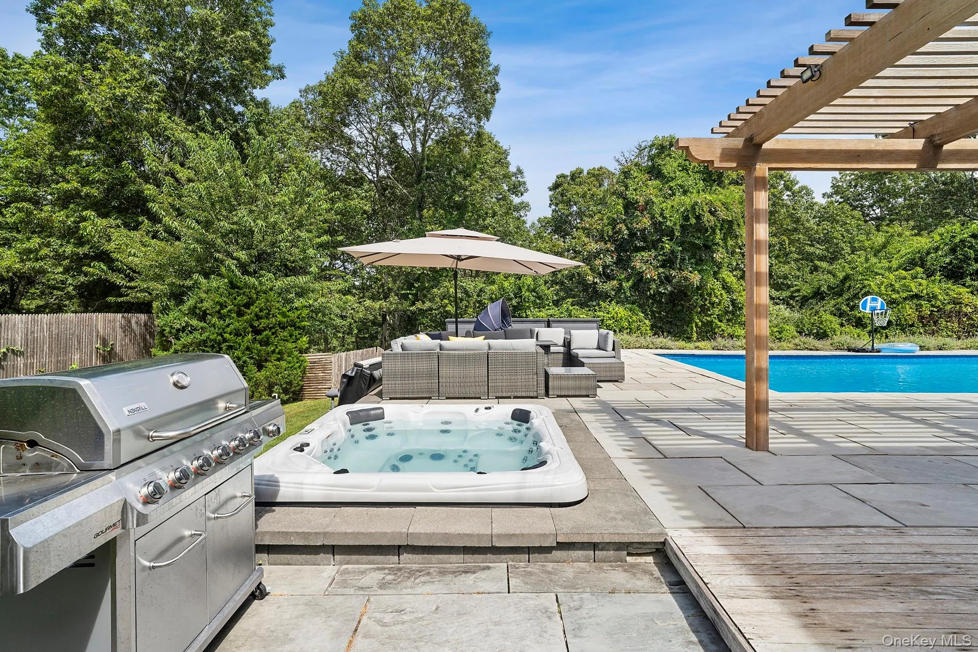 View of patio with an outdoor hot tub, an outdoor living space, a grill, a pergola, and an outdoor pool View of patio with an outdoor hot tub, an outdoor living space, a grill, a pergola, and an outdoor pool