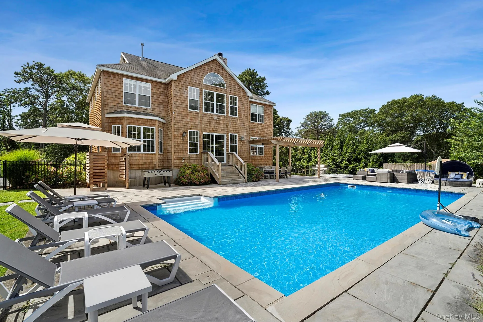 View of swimming pool with a patio area, a storage structure, an outdoor kitchen, and an outbuilding View of swimming pool with a patio area, a storage structure, an outdoor kitchen, and an outbuilding