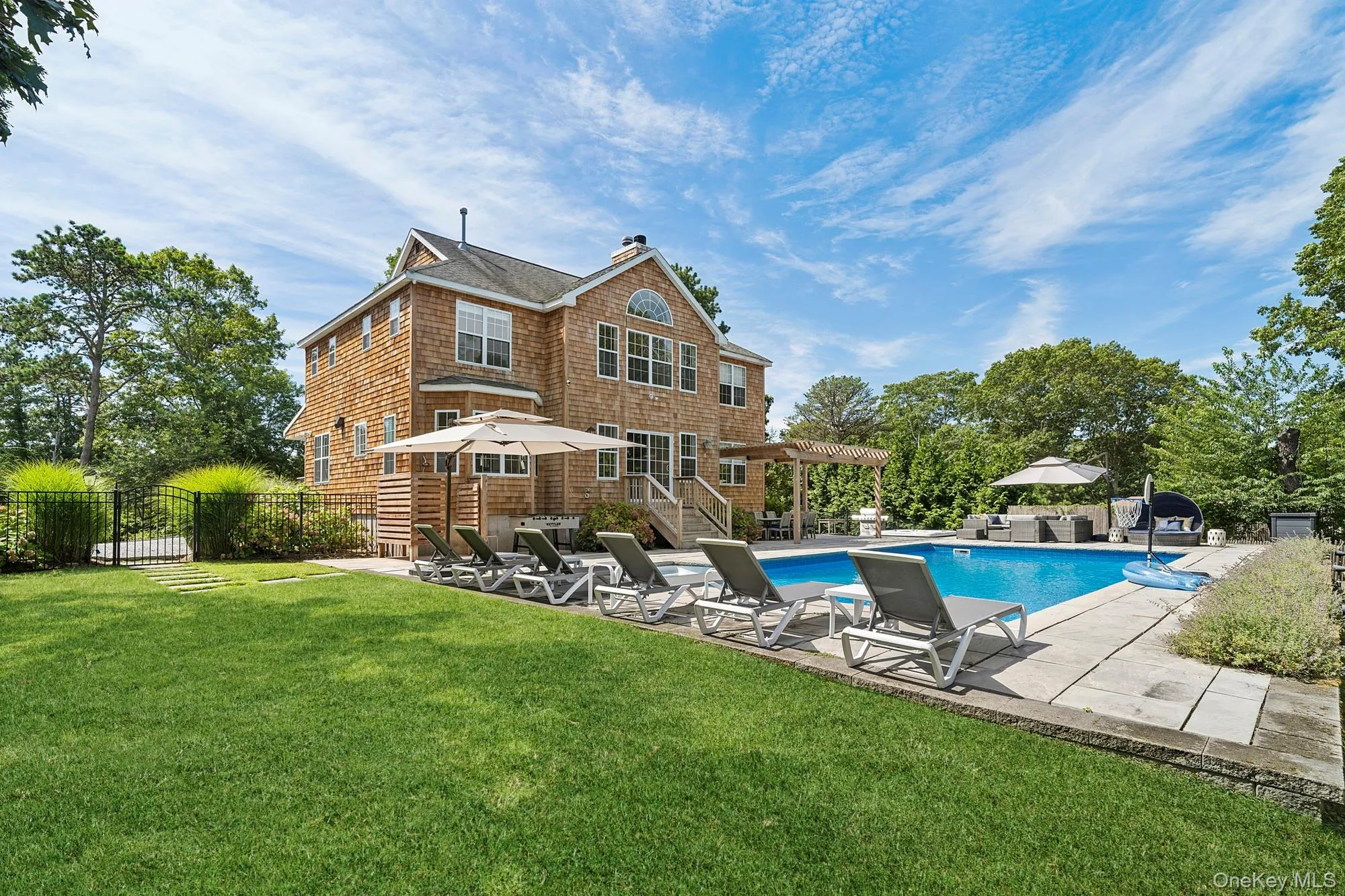 Rear view of house with a patio area and a chimney Rear view of house with a patio area and a chimney