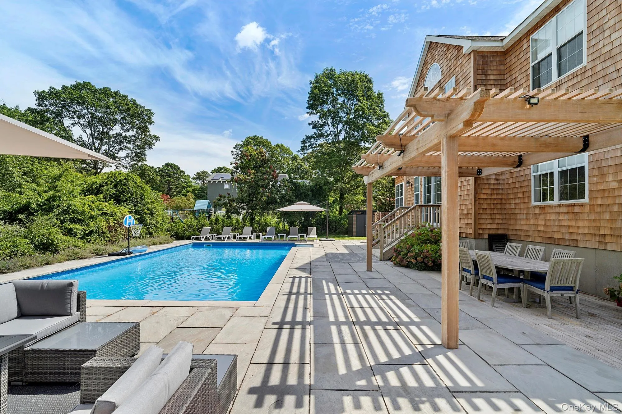 View of swimming pool featuring a patio area, a pergola, and outdoor dining space View of swimming pool featuring a patio area, a pergola, and outdoor dining space