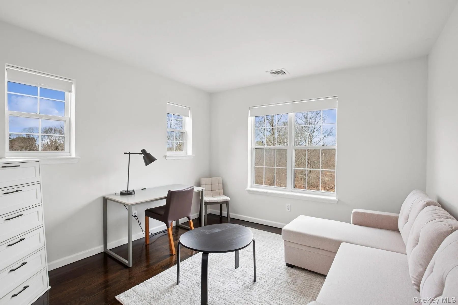 Office area featuring visible vents, baseboards, and dark wood-style floors Office area featuring visible vents, baseboards, and dark wood-style floors