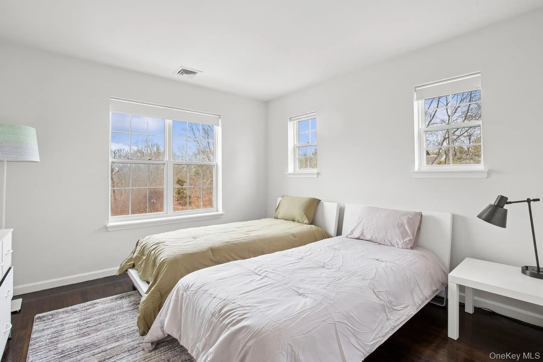 Bedroom with visible vents, baseboards, and dark wood finished floors Bedroom with visible vents, baseboards, and dark wood finished floors