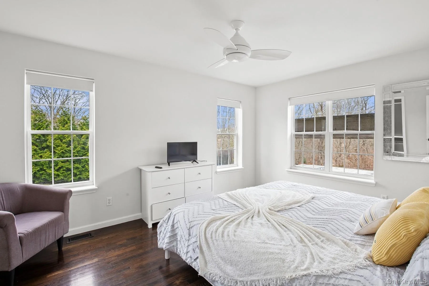 Bedroom featuring dark wood-type flooring, visible vents, baseboards, and a ceiling fan Bedroom featuring dark wood-type flooring, visible vents, baseboards, and a ceiling fan