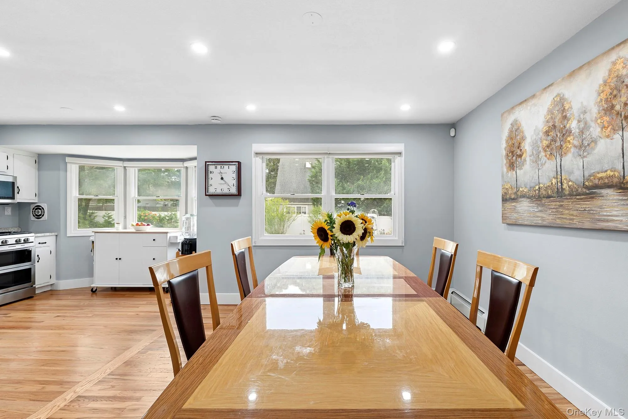 Dining area featuring recessed lighting, light wood-type flooring, and baseboard heating Dining area featuring recessed lighting, light wood-type flooring, and baseboard heating