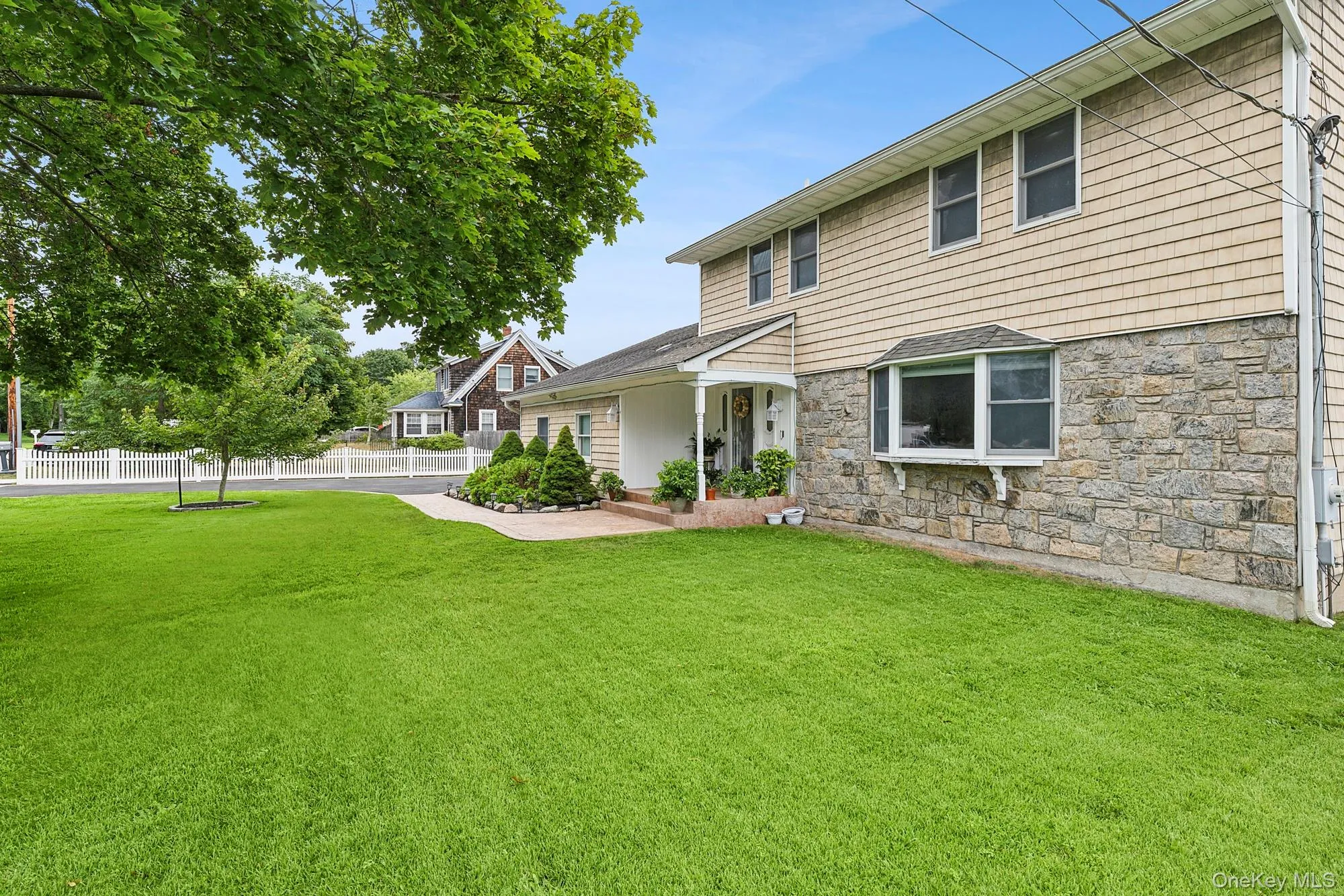 Front view of house with large, fenced in front yard Front view of house with large, fenced in front yard