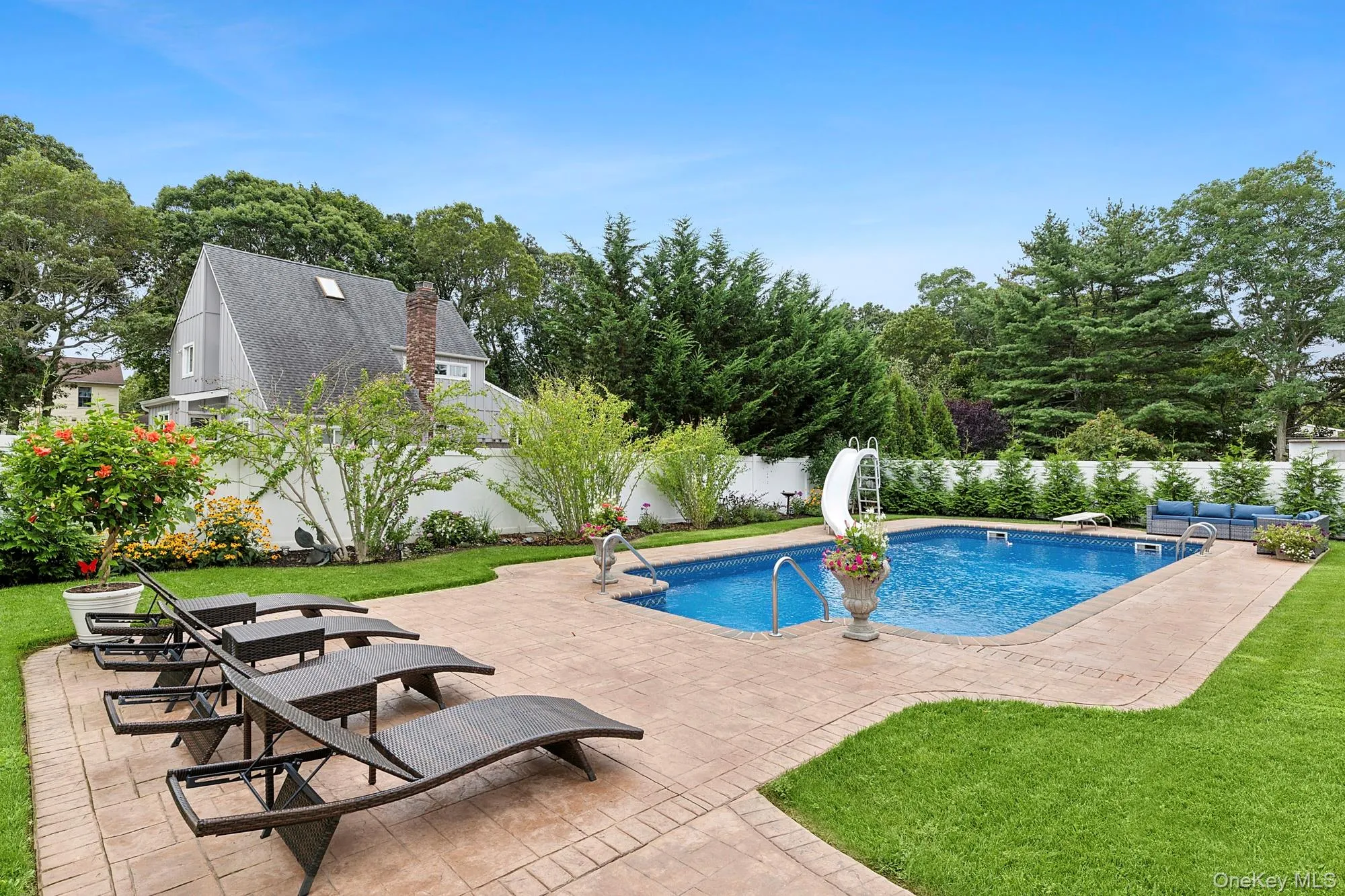 View of swimming pool featuring a patio area, a fenced backyard, and a water slide View of swimming pool featuring a patio area, a fenced backyard, and a water slide