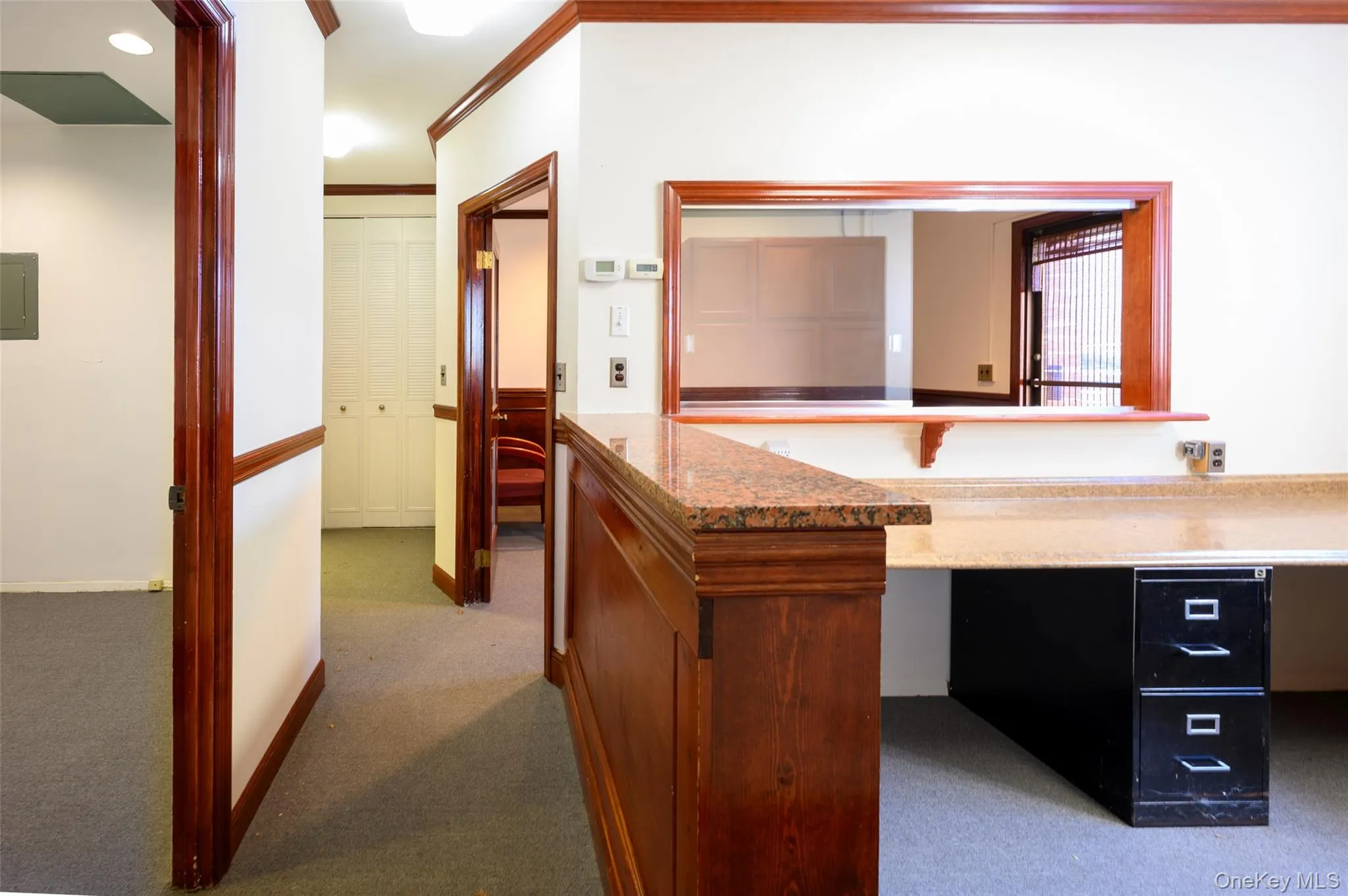 Corridor with crown molding, recessed lighting, carpet flooring, electric panel, and baseboards Corridor with crown molding, recessed lighting, carpet flooring, electric panel, and baseboards