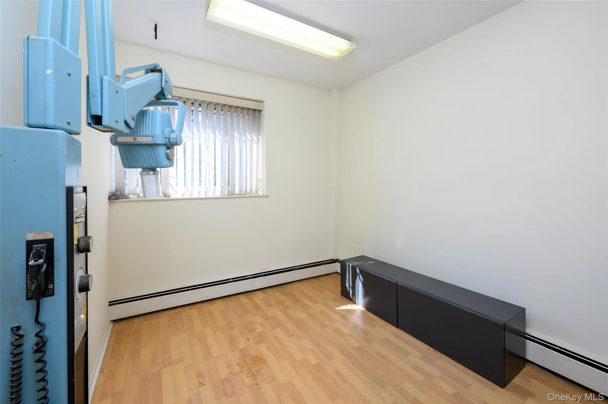 Spare room with baseboard heating and wood finished floors Spare room with baseboard heating and wood finished floors
