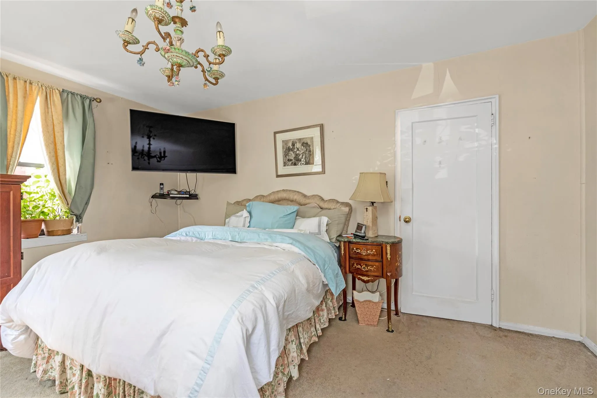 Bedroom featuring light carpet and baseboards Bedroom featuring light carpet and baseboards